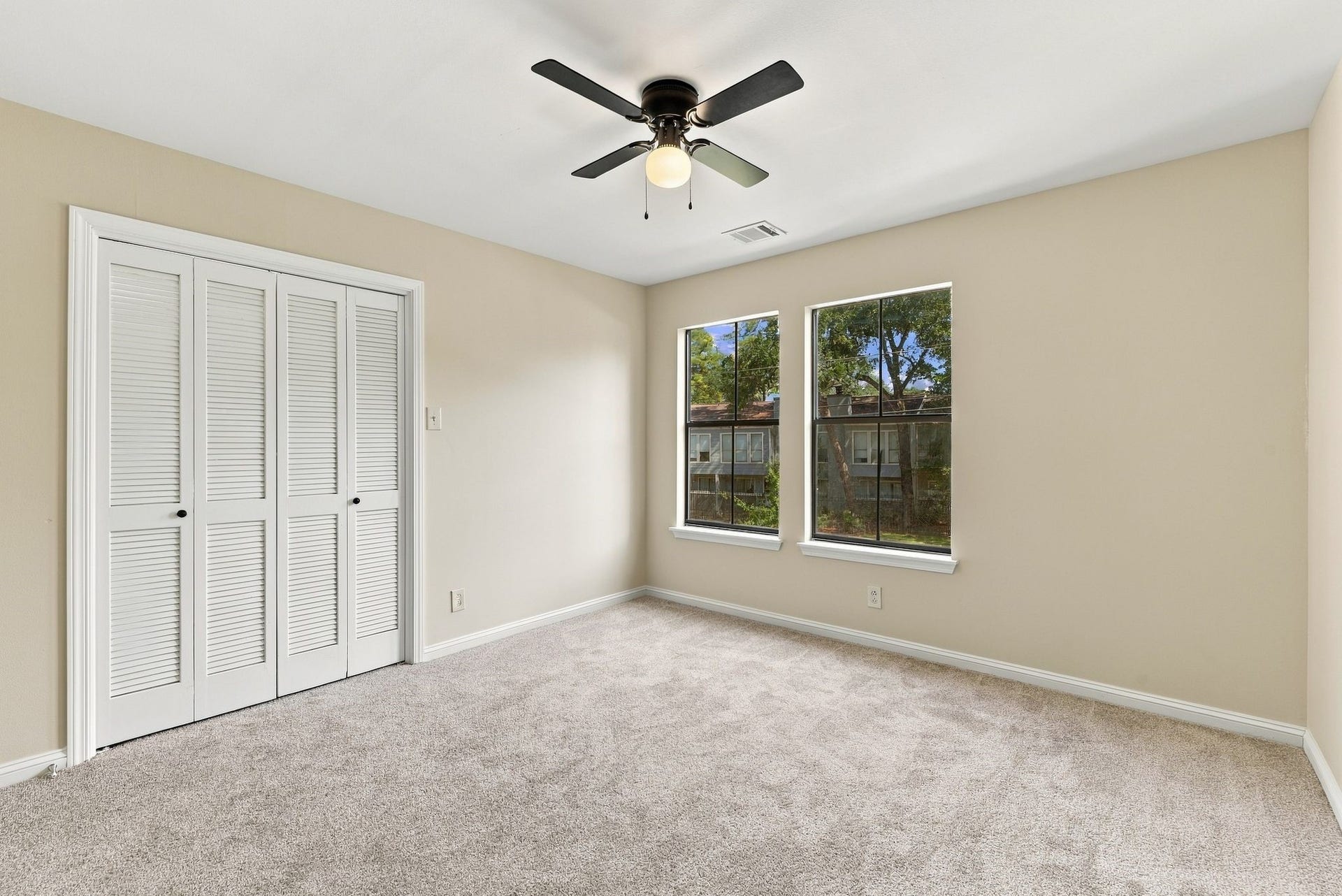 Additional view of the upstairs bedroom highlighting natural light and closet space.
