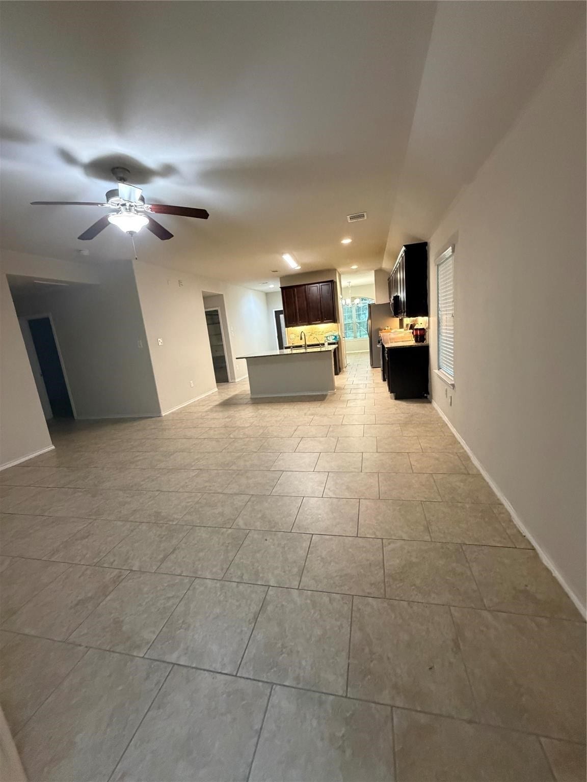 Spacious open-concept living area seamlessly connecting the living room, kitchen, and dining room.