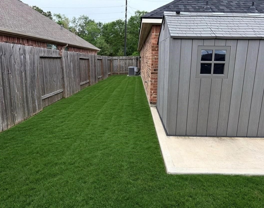 Expansive and well-maintained side yard, perfect for outdoor activities and gardening.