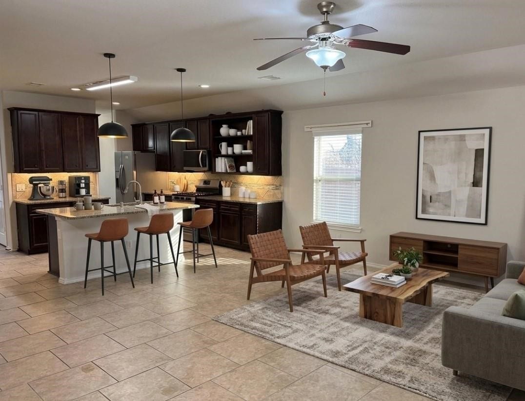 Experience the perfect blend of comfort and style in this virtually staged open-concept living area, featuring a modern kitchen, cozy breakfast Bar, and inviting living room.