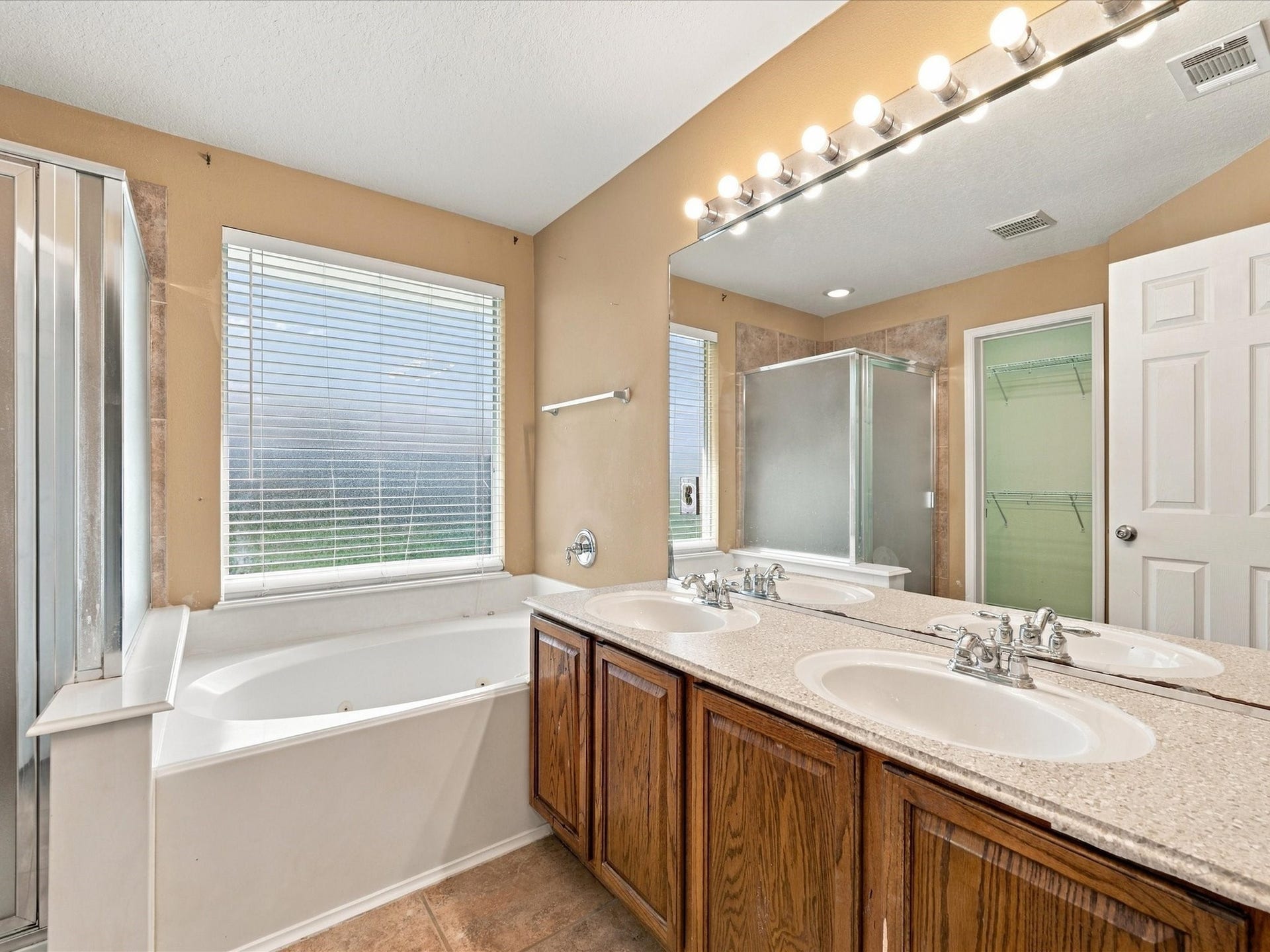 30026 Luna Lakes Drive, Spring, TX 77386 Unwind in the primary ensuite, featuring dual sinks, a relaxing jetted tub, and separate shower for added comfort and convenience.