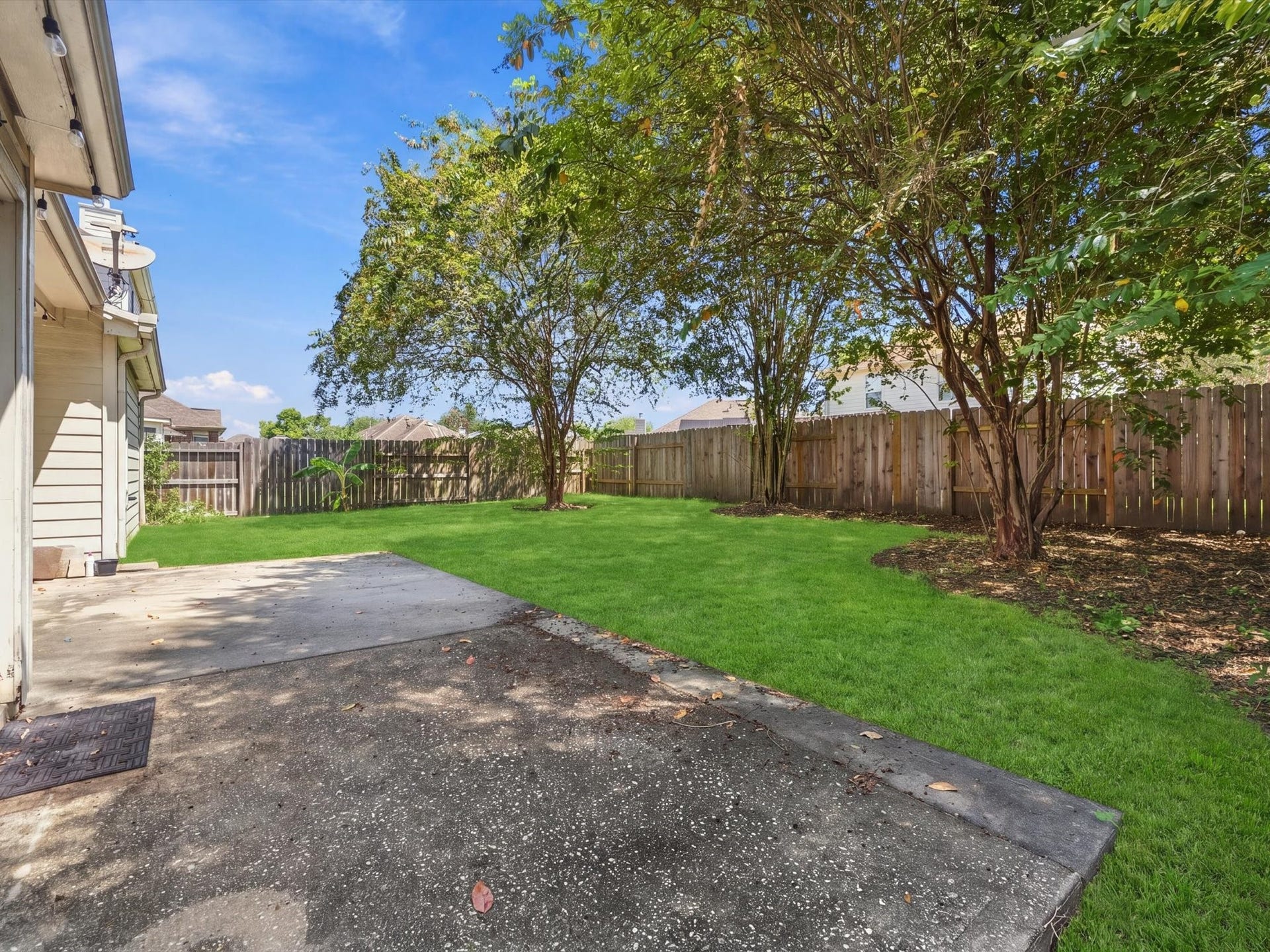 30026 Luna Lakes Drive, Spring, TX 77386 An expansive back patio and spacious backyard create an inviting setting for outdoor dining, entertaining, and enjoying time outside.