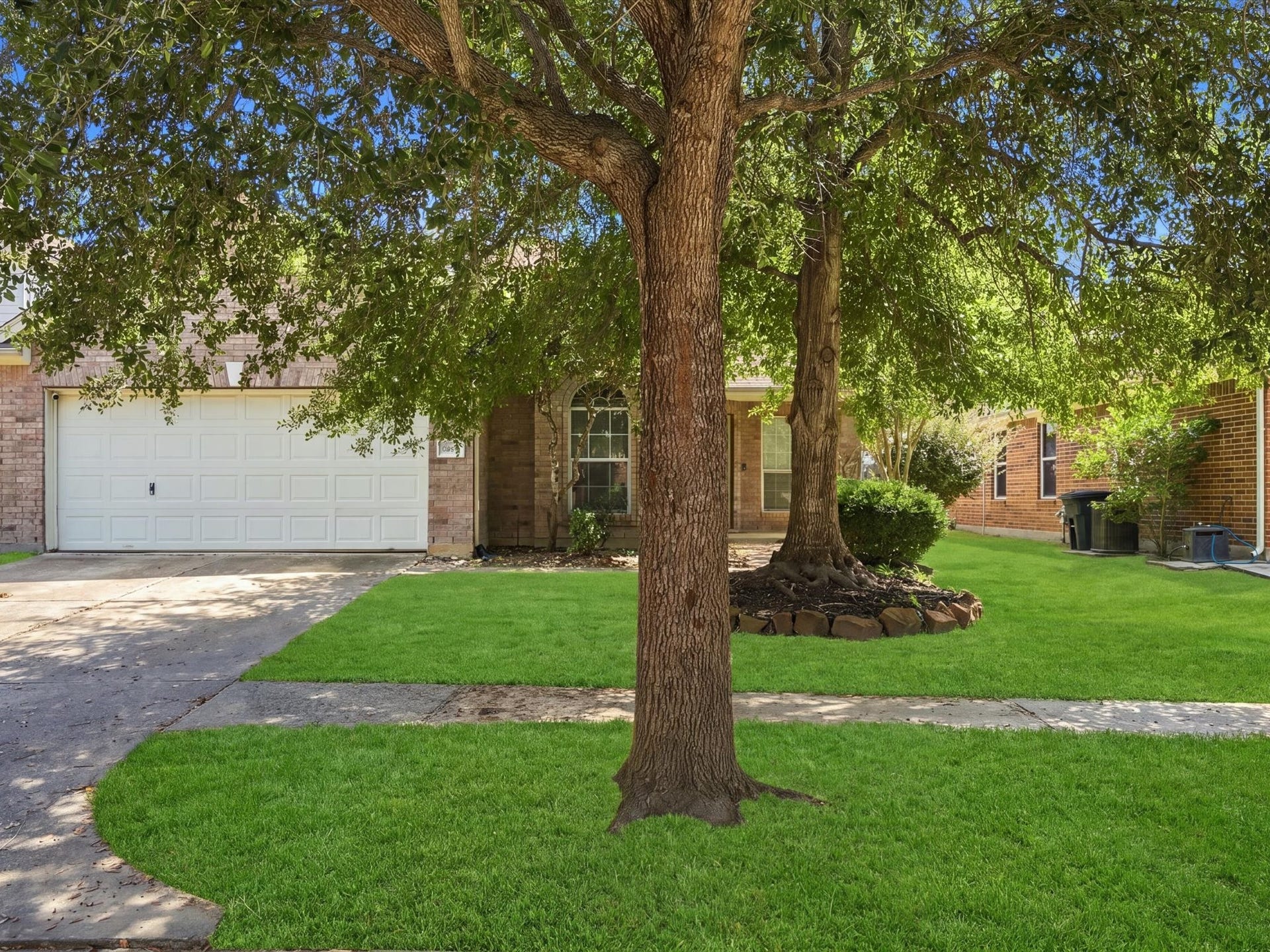 30026 Luna Lakes Drive, Spring, TX 77386 Natural charm and inviting curb appeal create a welcoming first impression, with digitally enhanced grass for illustrative purposes.