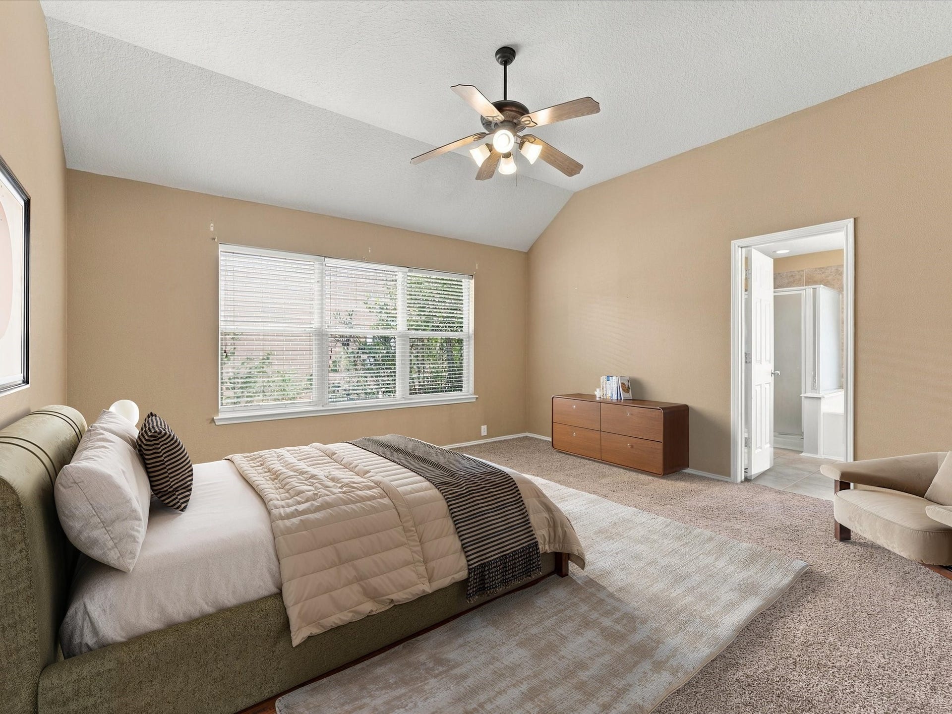 30026 Luna Lakes Drive, Spring, TX 77386 High ceilings and large windows fill the primary bedroom with natural light, creating a bright, restful retreat with the convenience of an ensuite bathroom.