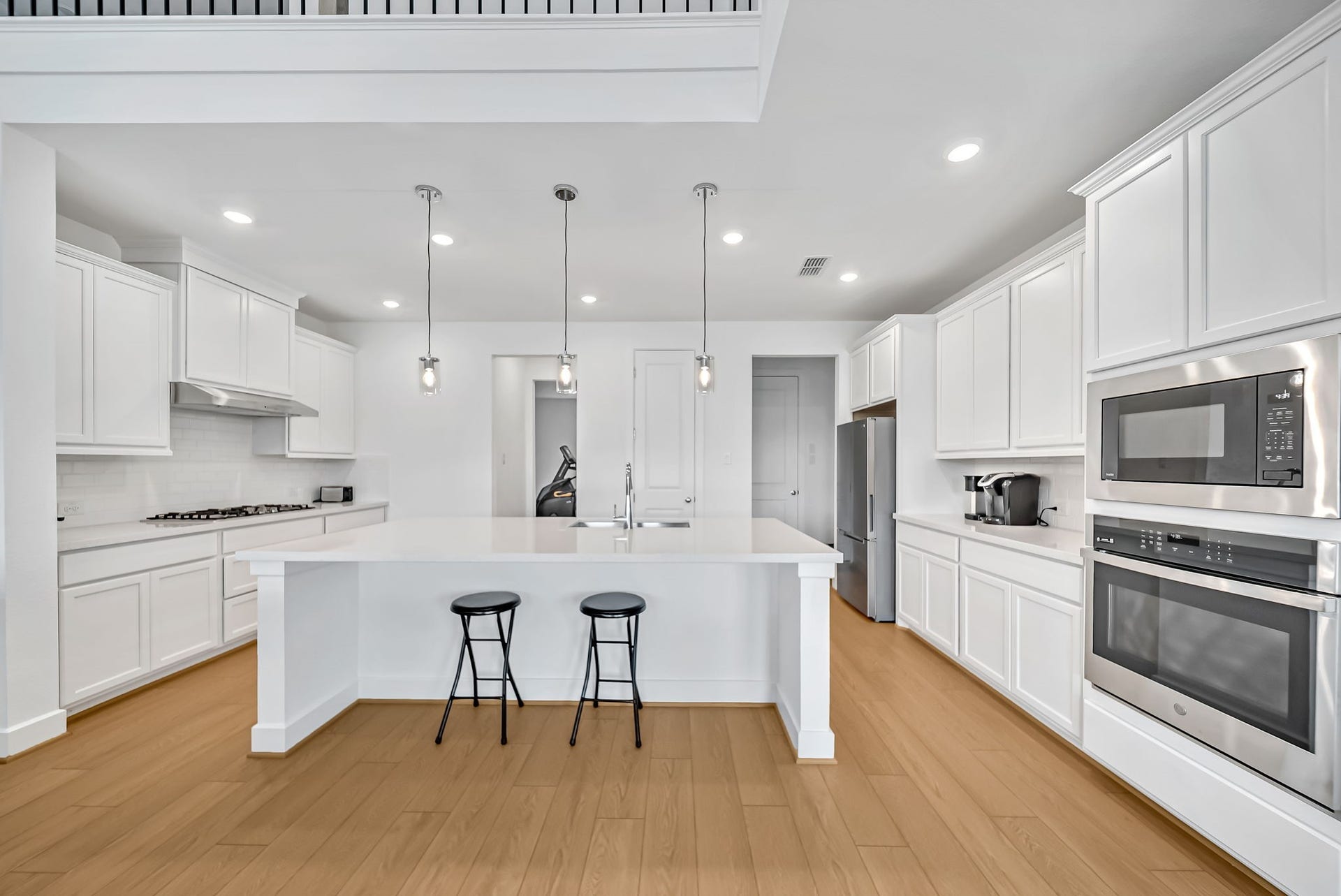 2116 Lila Sky Lane, Friendswood, TX 77546 Bright & Airy Open-Concept Kitchen for Entertaining. Island and huge walk-in pantry.