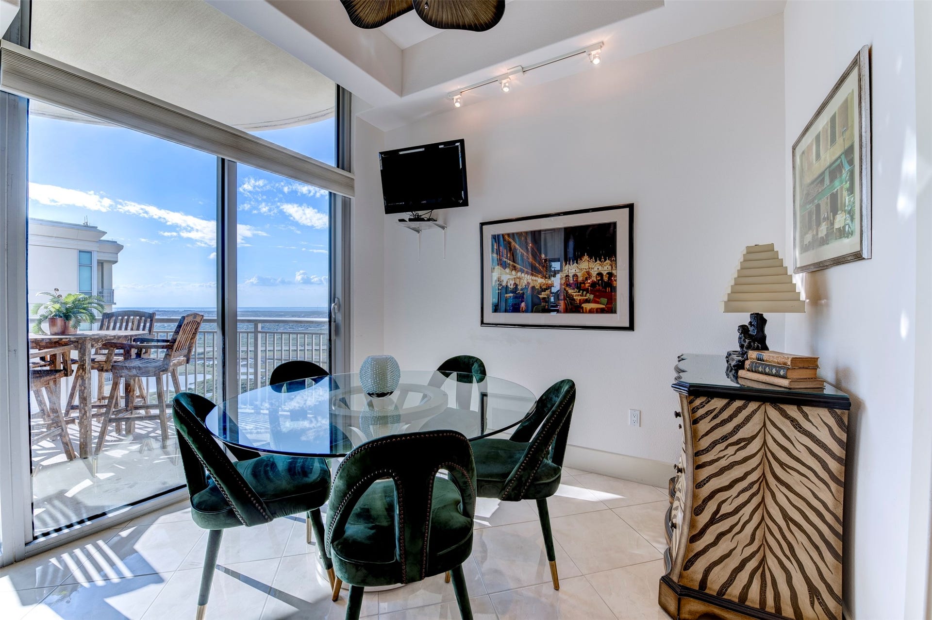 801 E Beach Drive, #BC2808, Galveston, TX 77550 Bright breakfast area sits beside the balcony, with floor-to-ceiling glass and open views beyond