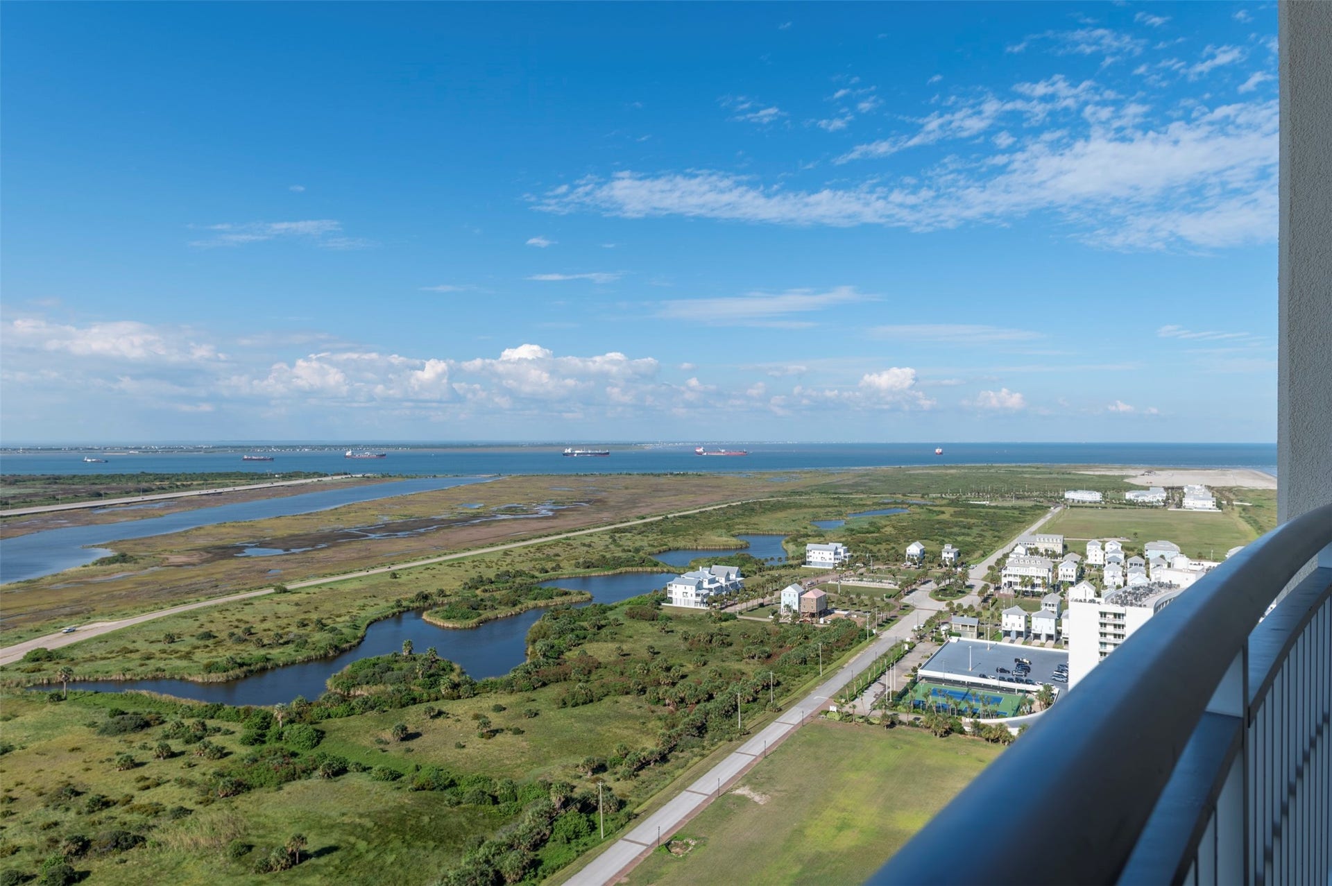 801 E Beach Drive, #BC2808, Galveston, TX 77550 Expansive eastward views from your master balcony stretch across the wetlands and bay, with ships in the channel and the island extending into the distance.