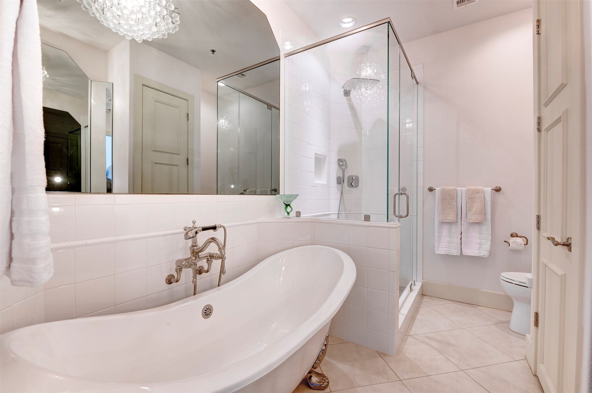801 E Beach Drive, #BC2808, Galveston, TX 77550 Claw-foot tub and oversized glass shower are complemented by crystal lighting