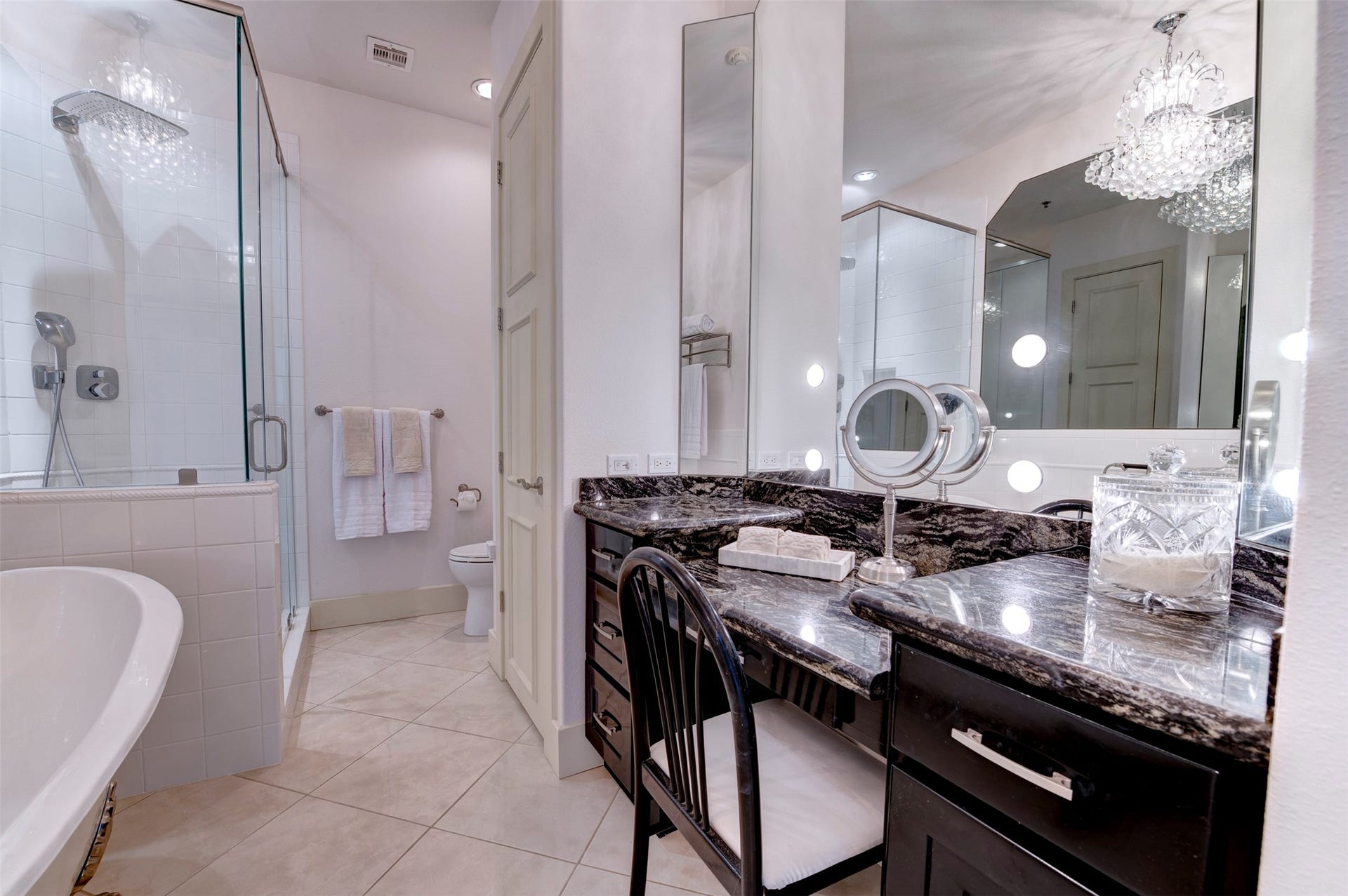 801 E Beach Drive, #BC2808, Galveston, TX 77550 Primary bath features a generous seated vanity area, extensive mirror space and a large glass-enclosed shower.