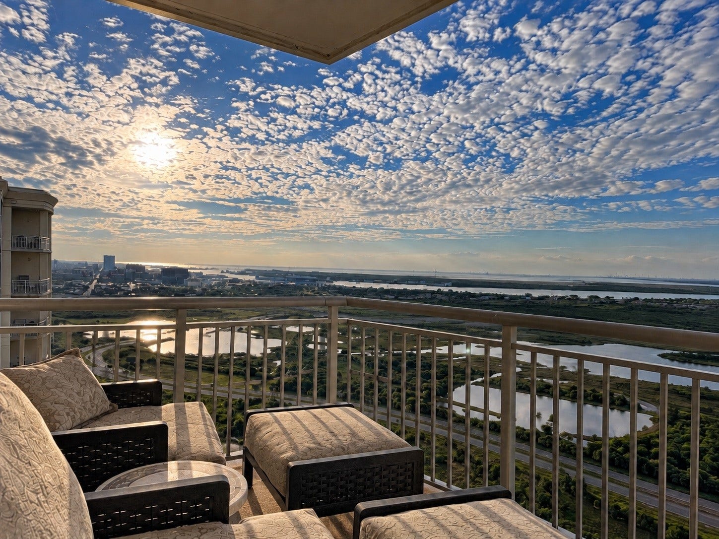801 E Beach Drive, #BC2808, Galveston, TX 77550 Looking west from the north-facing balcony extends the living space outdoors, with westward views across the bay, wetlands and city.