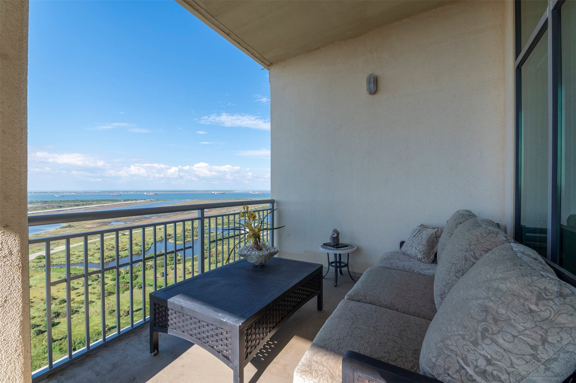 801 E Beach Drive, #BC2808, Galveston, TX 77550 Private balcony off the bay-view primary suite offers a comfortable outdoor seating area high above the island.