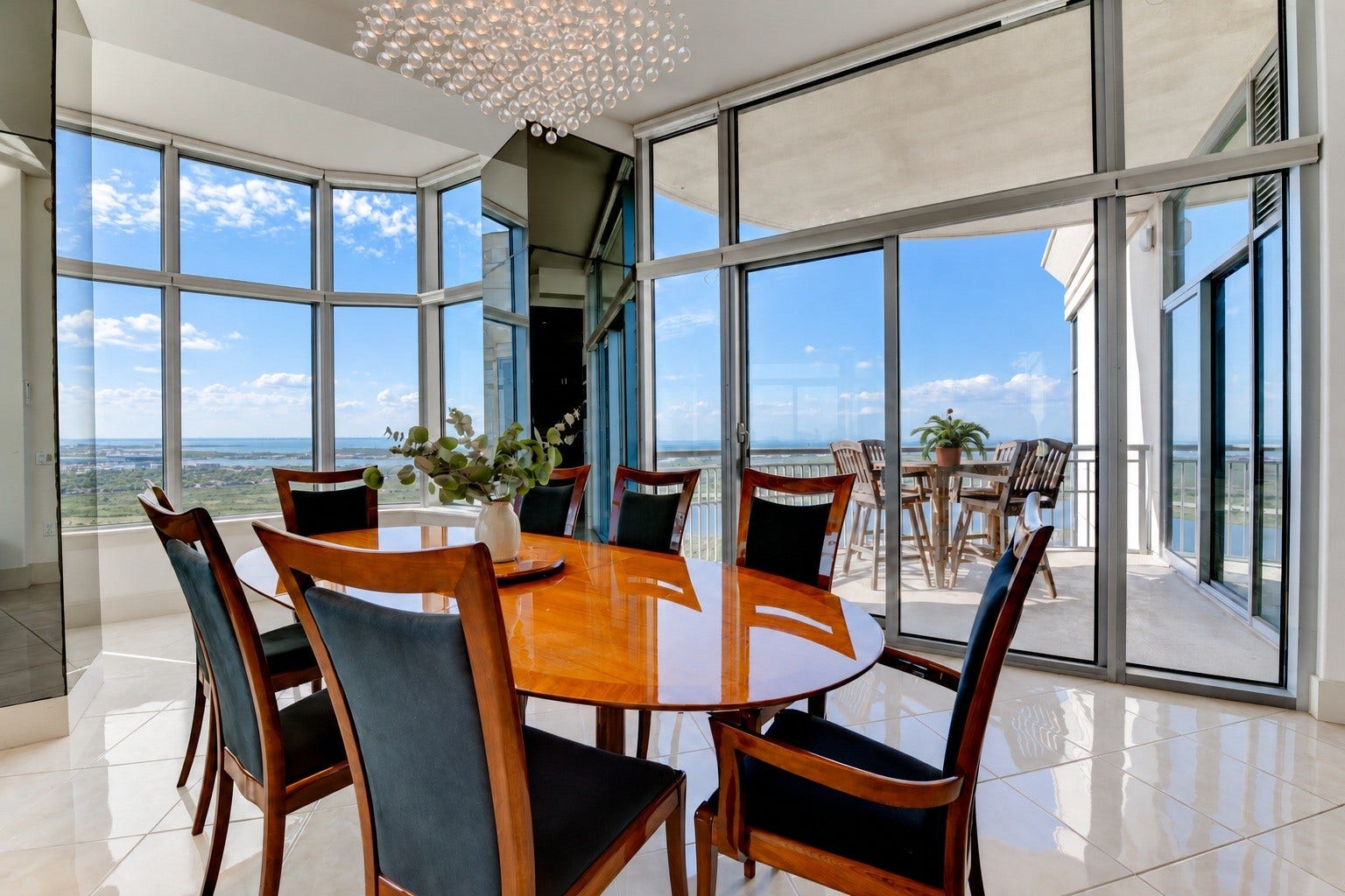 801 E Beach Drive, #BC2808, Galveston, TX 77550 Custom-made Italian dining table anchors the spacious dining area, with direct balcony access and water views beyond.