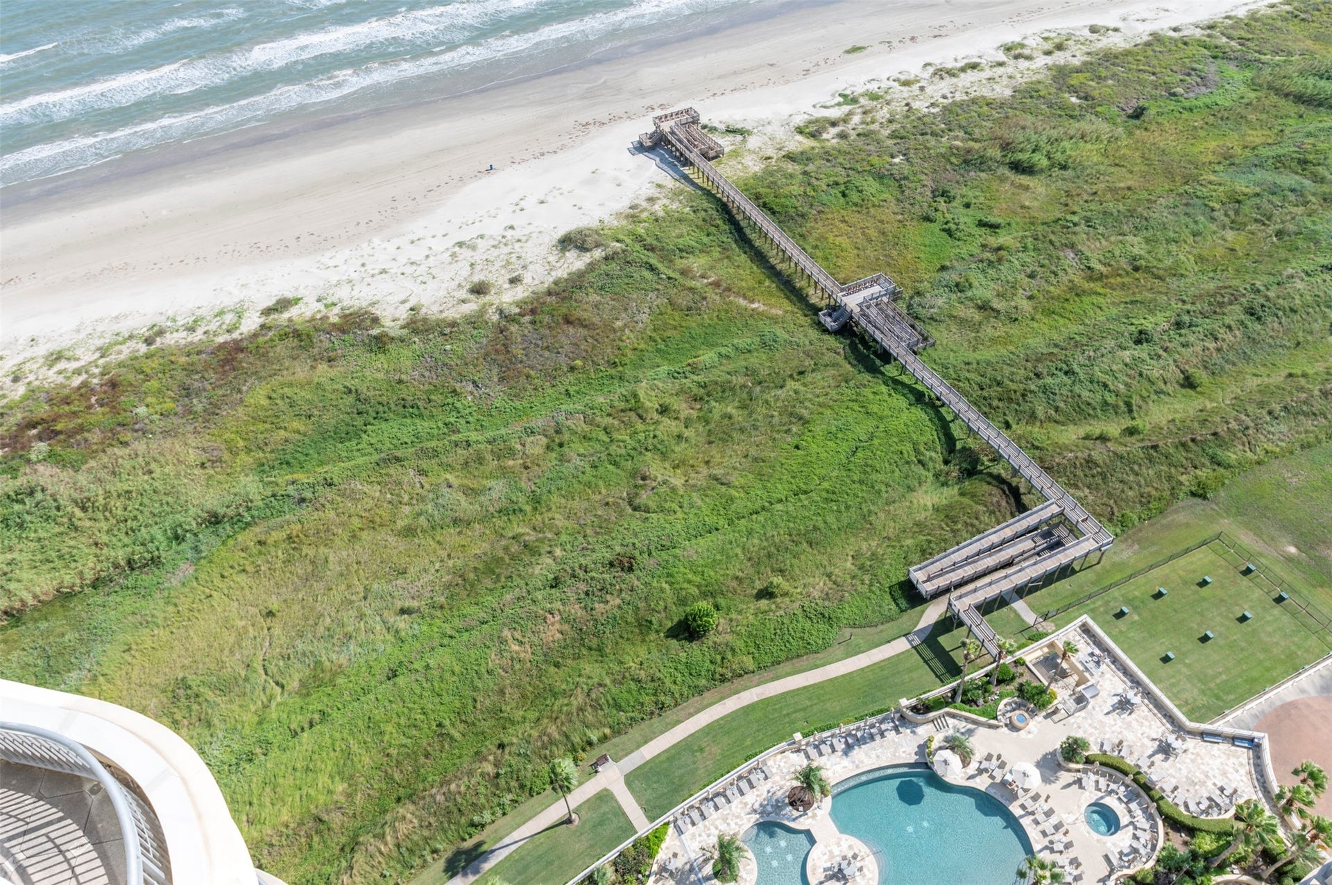 801 E Beach Drive, #BC2808, Galveston, TX 77550 From the 28th floor, the view looks straight down to Palisade Palms pool deck, private beach access and the Gulf beyond.
