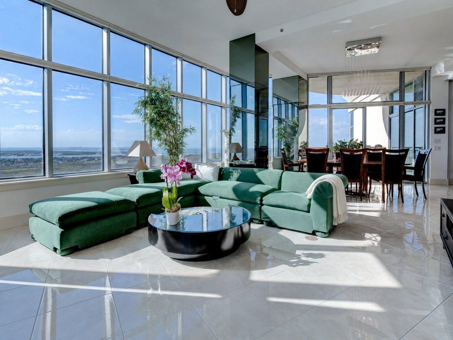 801 E Beach Drive, #BC2808, Galveston, TX 77550 Penthouse living with soaring 11'4" ceilings, expansive living and dining areas, and walls of glass framing sweeping water and island views
