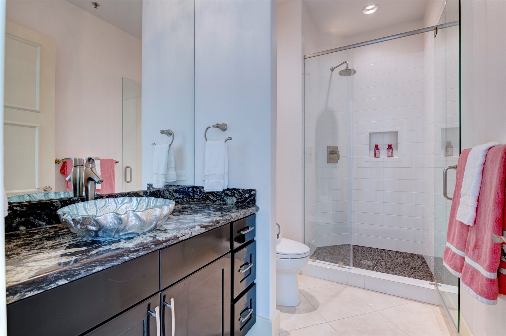 801 E Beach Drive, #BC2808, Galveston, TX 77550 Third bath features a large glass-enclosed shower with rainfall showerhead and pebble-stone floor.