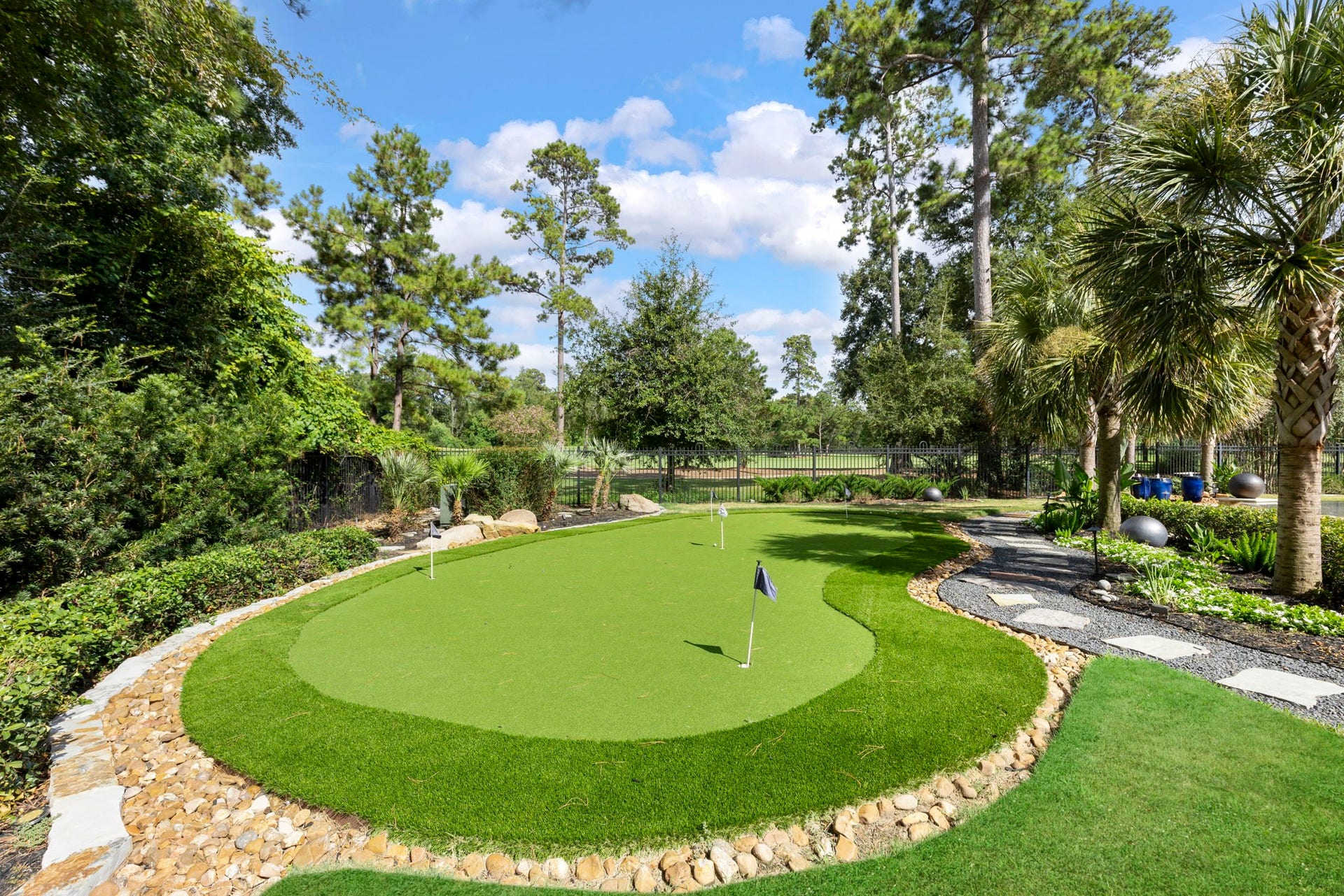 A three-hole putting green with river-rock border invites you to sharpen your short game right at home!