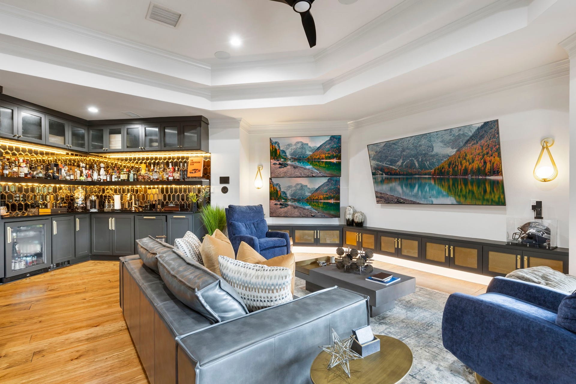 Additional highlights include a soaring tray ceilings and back-lit floating cabinetry.