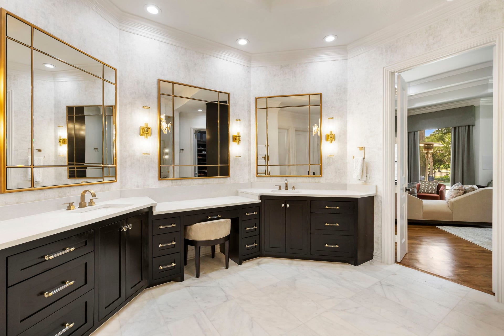 Sophisticated primary en suite affords every luxury, here his & her vanities and makeup counter.