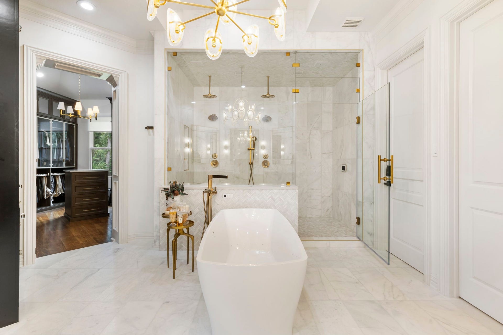 Enjoy a handsome closet for him with generous built-ins and a 2nd stunning closet for her that includes dressing/relaxing space, a built-in steamer, stackable washer/dryer and abundant storage and display both by California Closets.