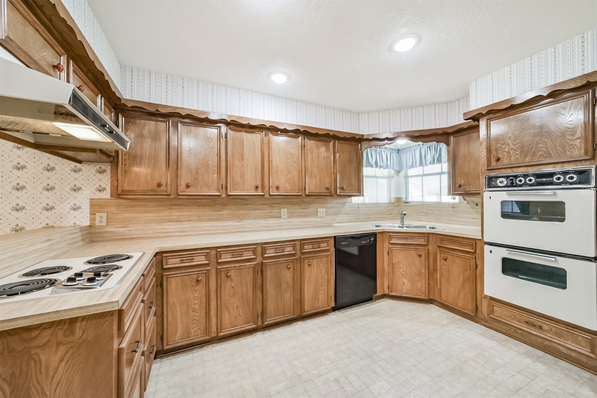 601 Kimswick C Court, Deer Park, TX 77536 Enjoy abundant cabinet space and timeless craftsmanship in this kitchen. Originally built in 1980, the handcrafted cabinetry reflects the quality and attention to detail of its era. The butcher-block-style countertops add warmth and versatility, complementing a variety of decorating styles.