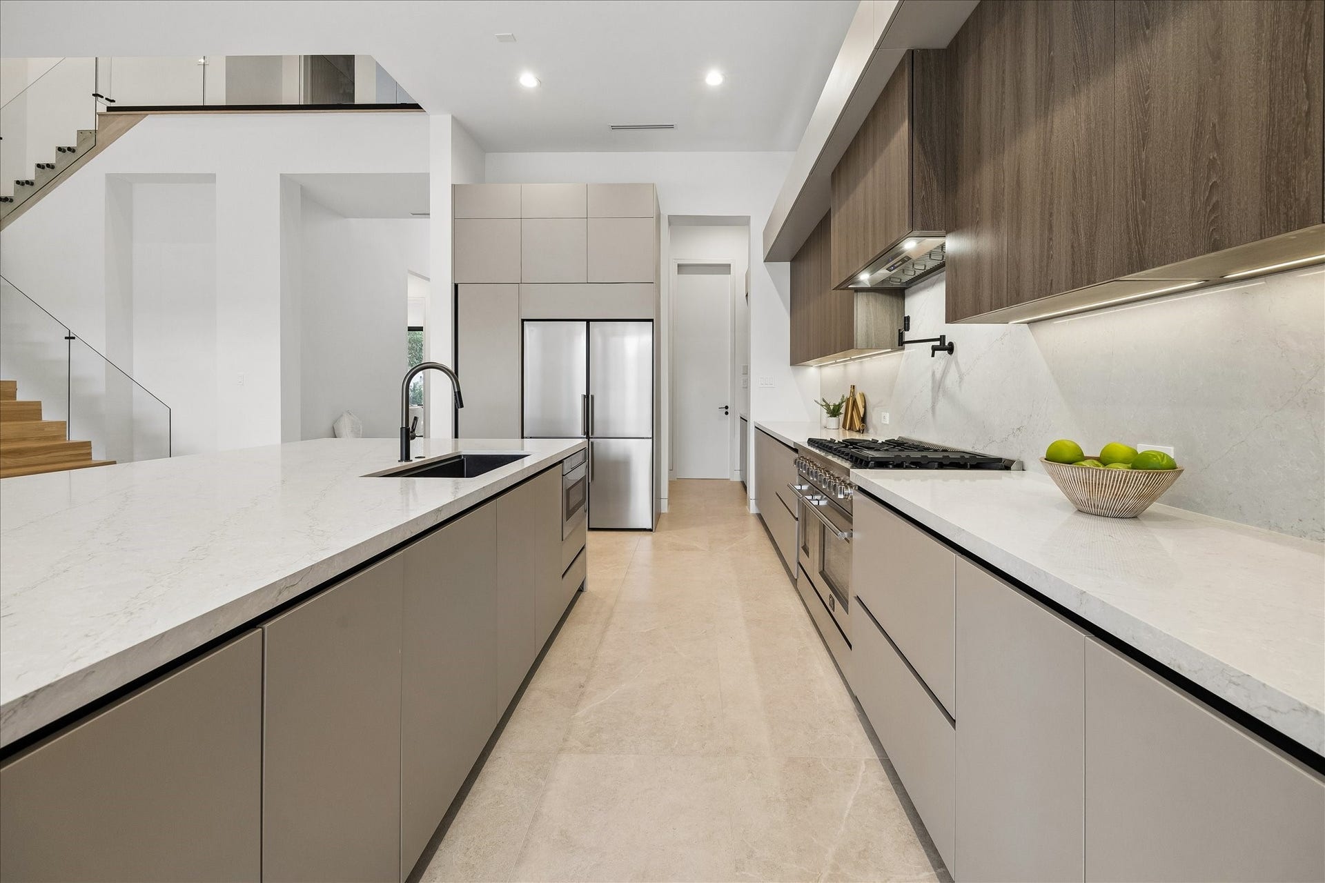Sleek cabinetry, marble countertops, and stainless steel appliances. A spacious layout with plenty of natural light and minimalist design.