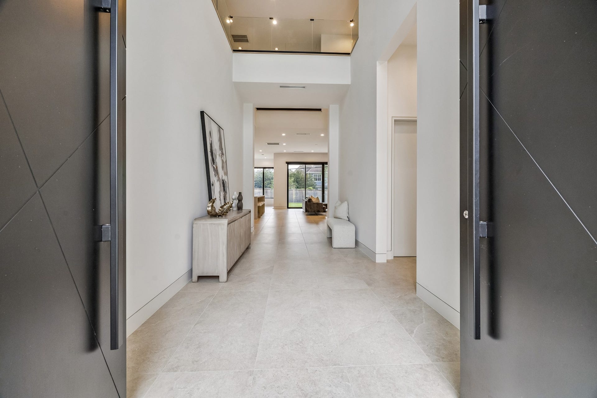 Double door entry opens to soaring two story ceilings