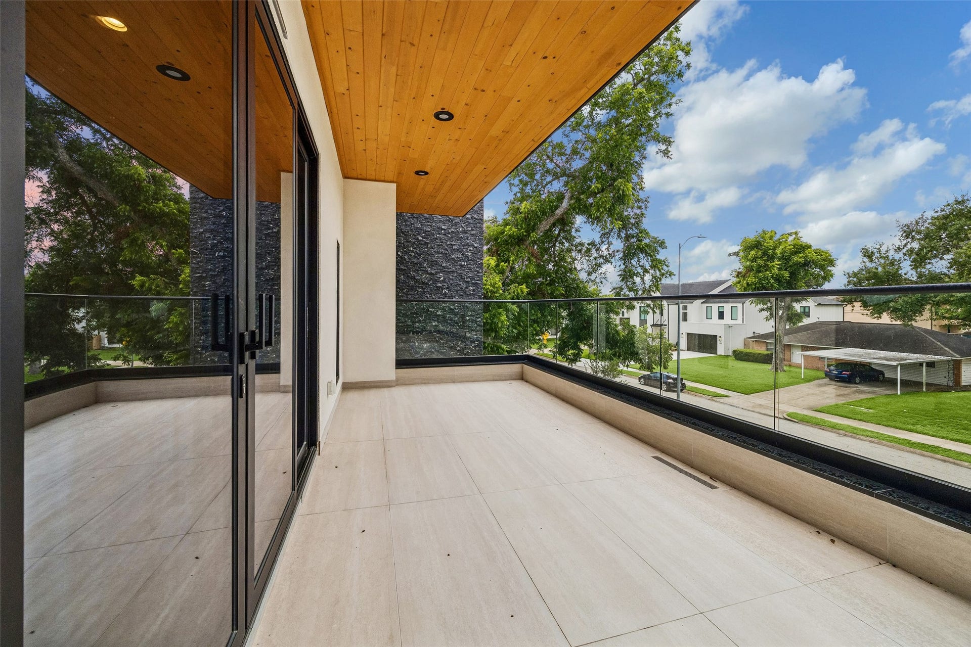 Sliding glass doors open to a large private balcony off the primary bedroom