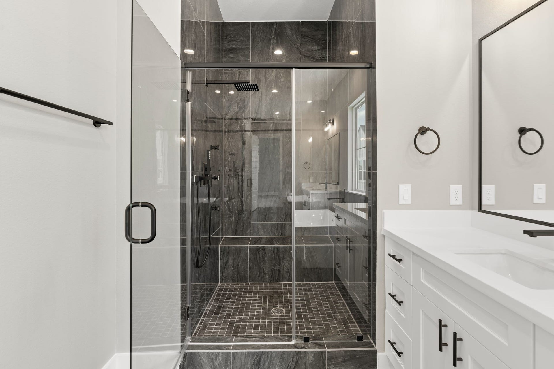 1175 W 19th Street, Houston, TX 77008 Standing shower with seat and sleek design.