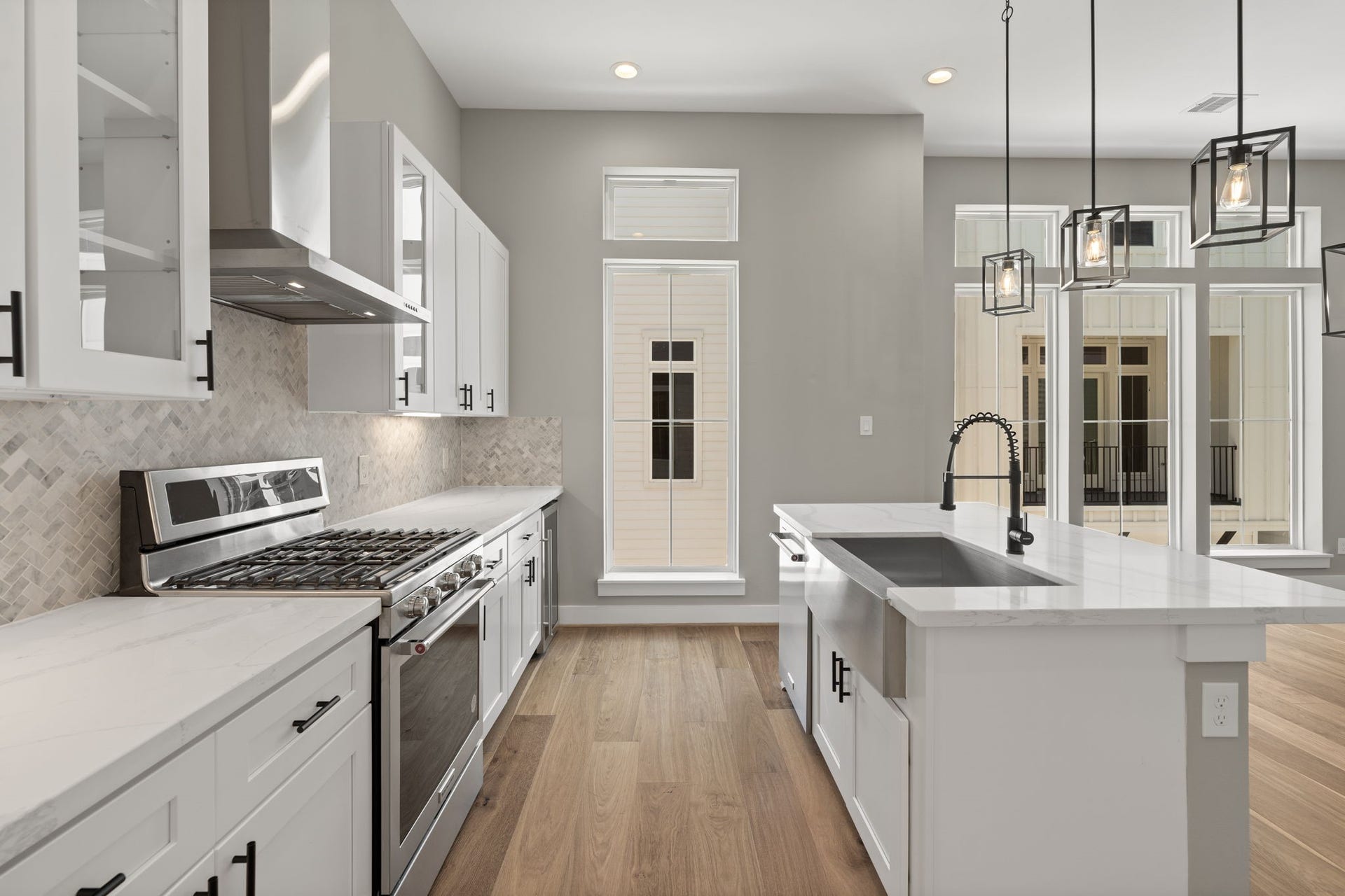 1175 W 19th Street, Houston, TX 77008 Stainless steel appliances with lovely herringbone backsplash.