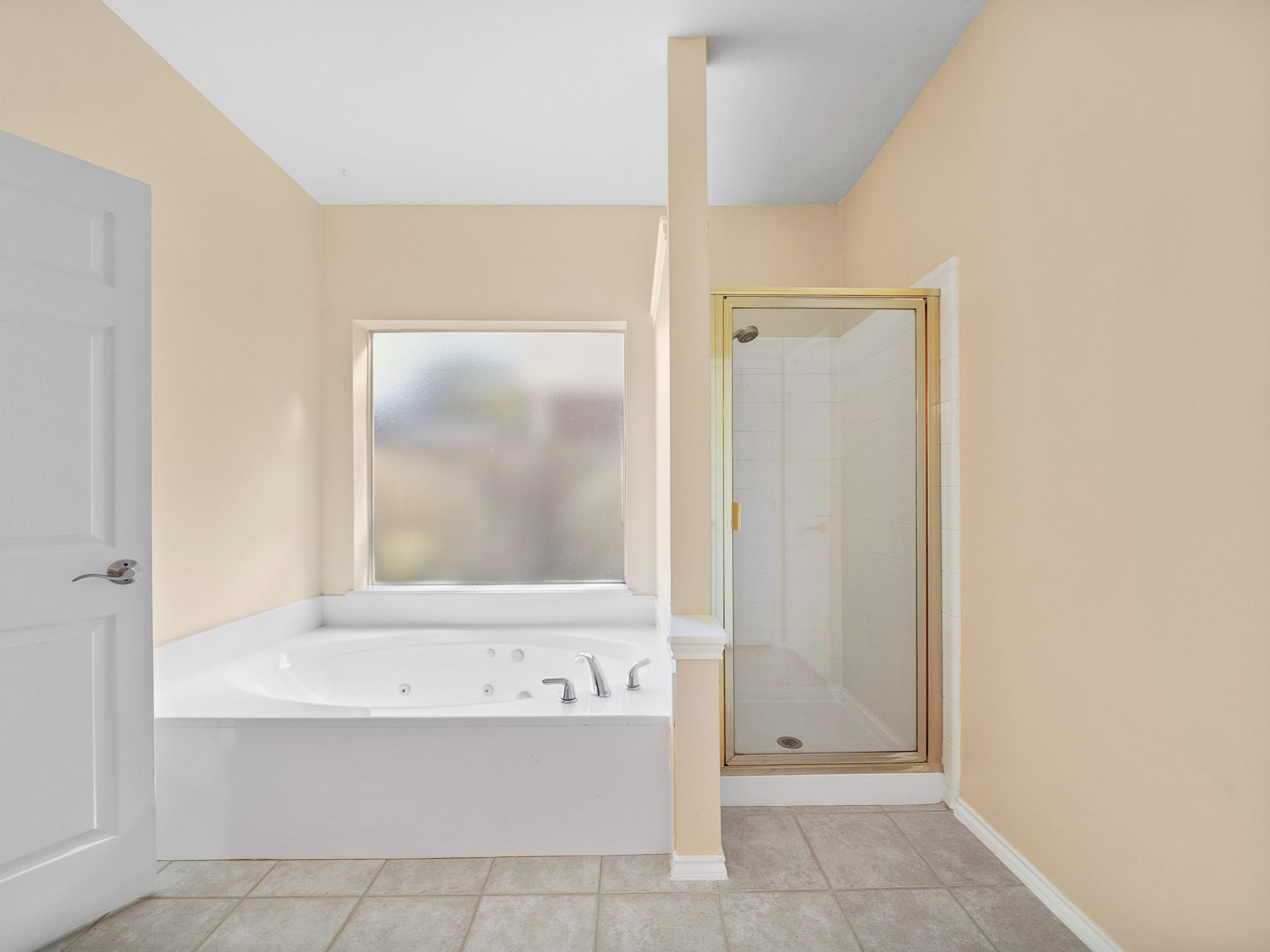 22510 Westenfield Lane, Katy, TX 77450 Let the day drift away in the jetted tub, tucked beneath a window for a peaceful setting. A separate shower adds convenience to the primary bath.