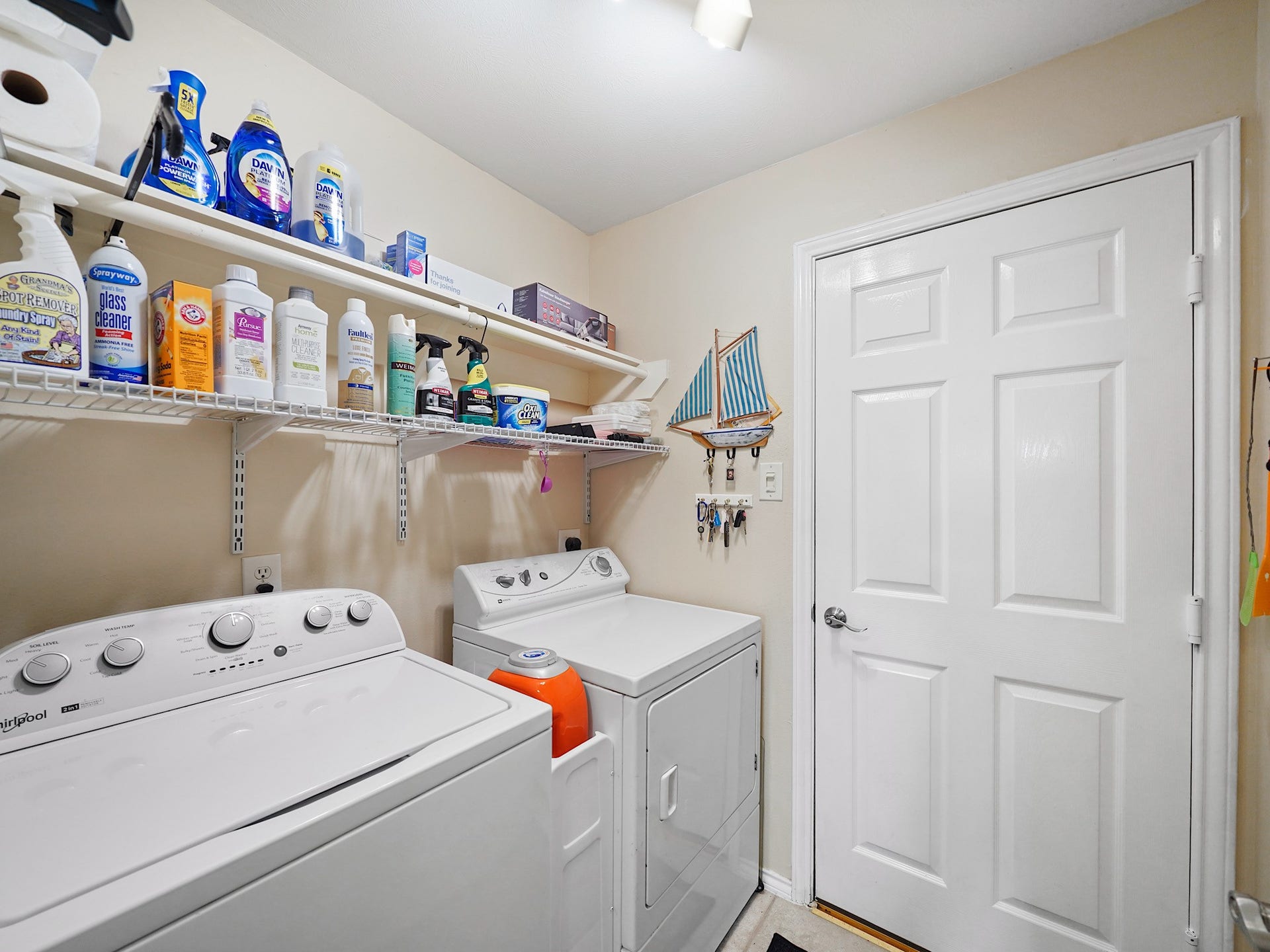 22510 Westenfield Lane, Katy, TX 77450 The utility room offers space for a side-by-side washer and dryer, with overhead shelving to keep laundry essentials within reach.