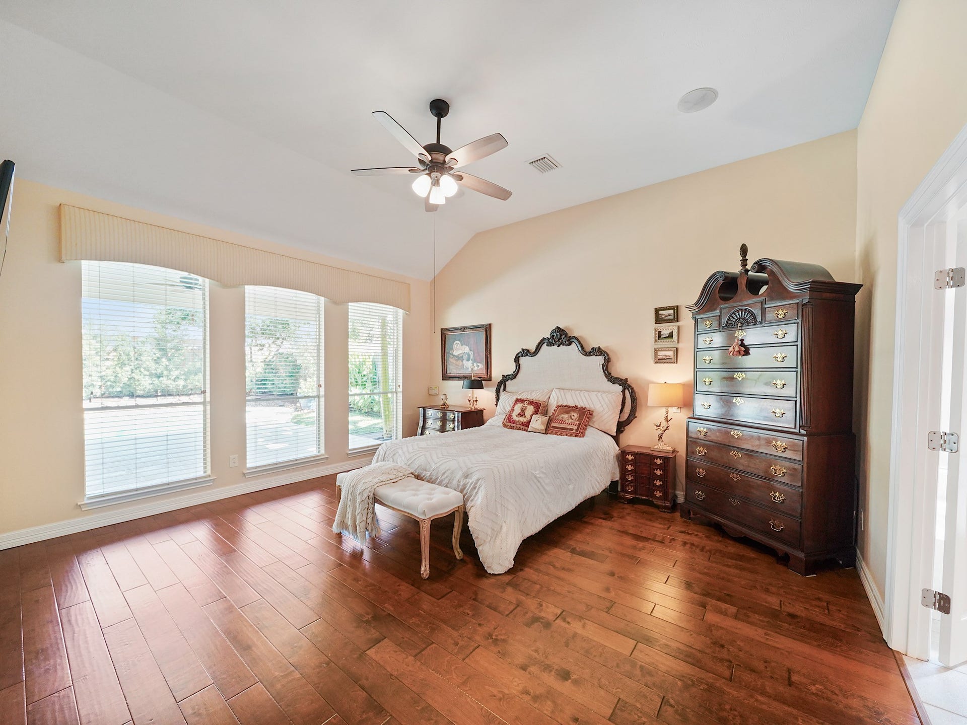 22510 Westenfield Lane, Katy, TX 77450 The downstairs primary retreat offers a peaceful place to unwind, with wood flooring and generous windows that welcome in natural light. Its spacious layout creates a comfortable setting to begin and end each day.
