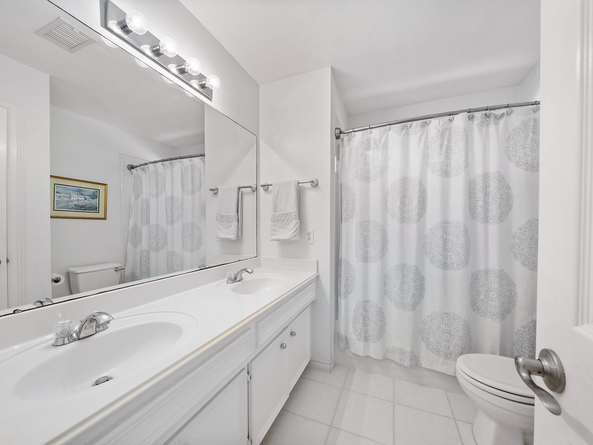 22510 Westenfield Lane, Katy, TX 77450 The upstairs bathroom features a dual-sink vanity with storage and a tub-and-shower combination. Its practical layout makes busy mornings and evening routines a little easier.
