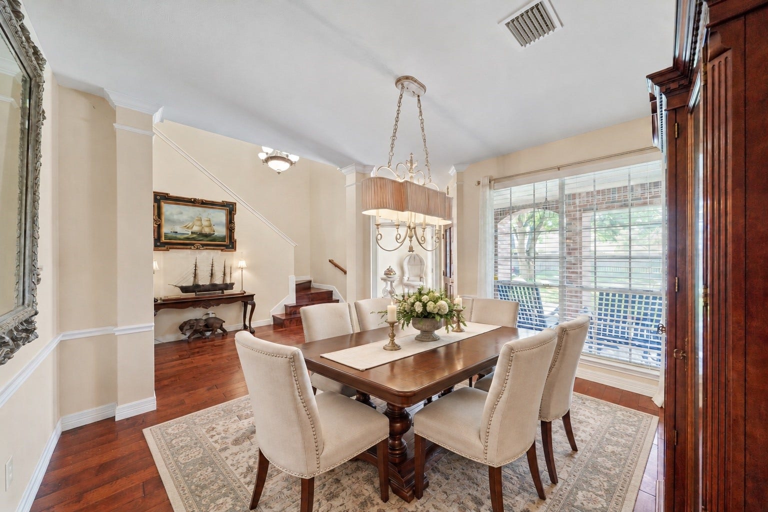 22510 Westenfield Lane, Katy, TX 77450 Virtually Staged: This formal dining room has been styled to show how comfortably the space can host family dinners and special occasions. Warm wood flooring and a large window create an inviting backdrop for gatherings.