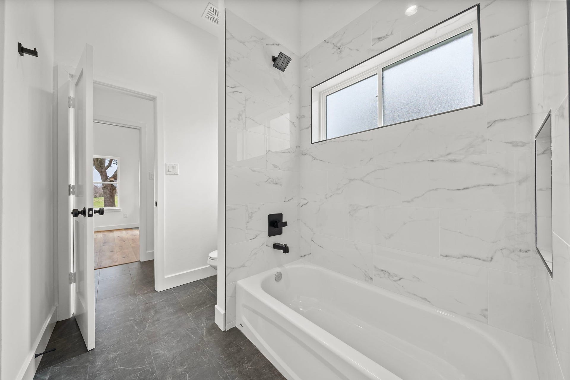 Shared shower/tub combo for Secondary Bedrooms 1 and 2