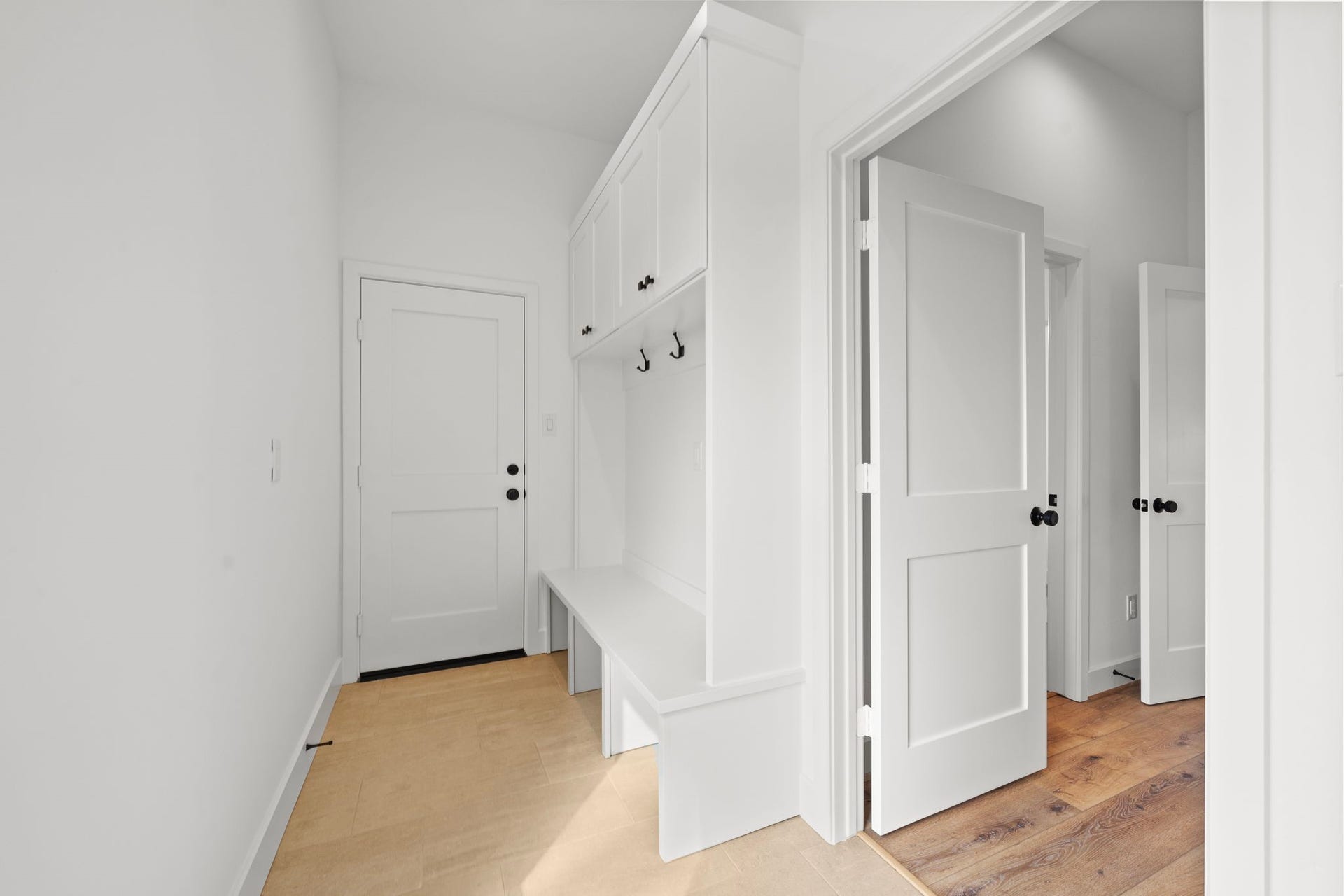 1 of 2 garage entrances into the home. Fantastic custom built-in for housing jackets and shoes!