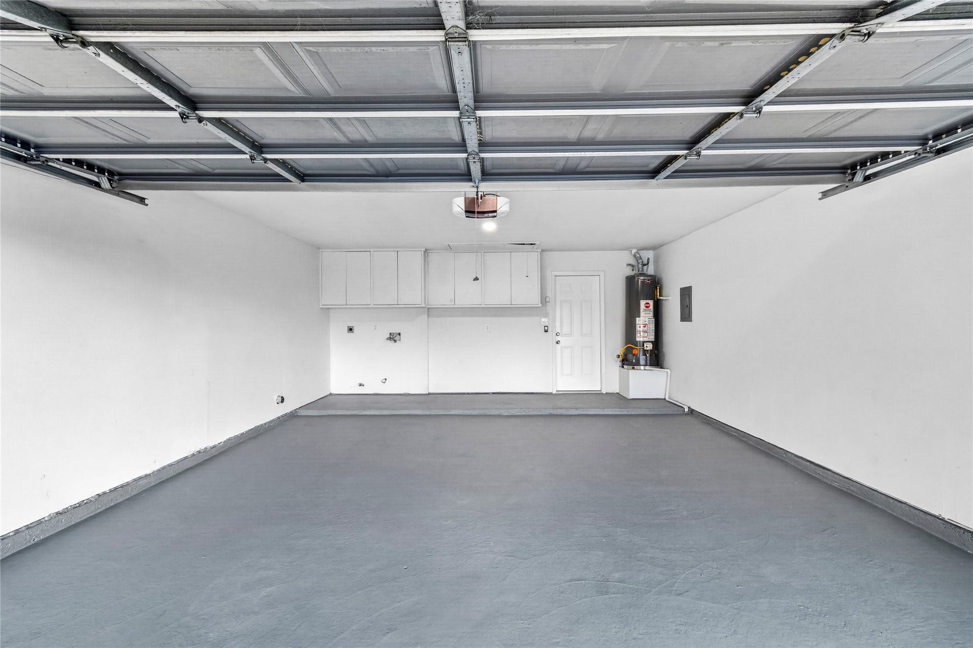 Two car garage with an automatic opener and washer dryer hook-ups