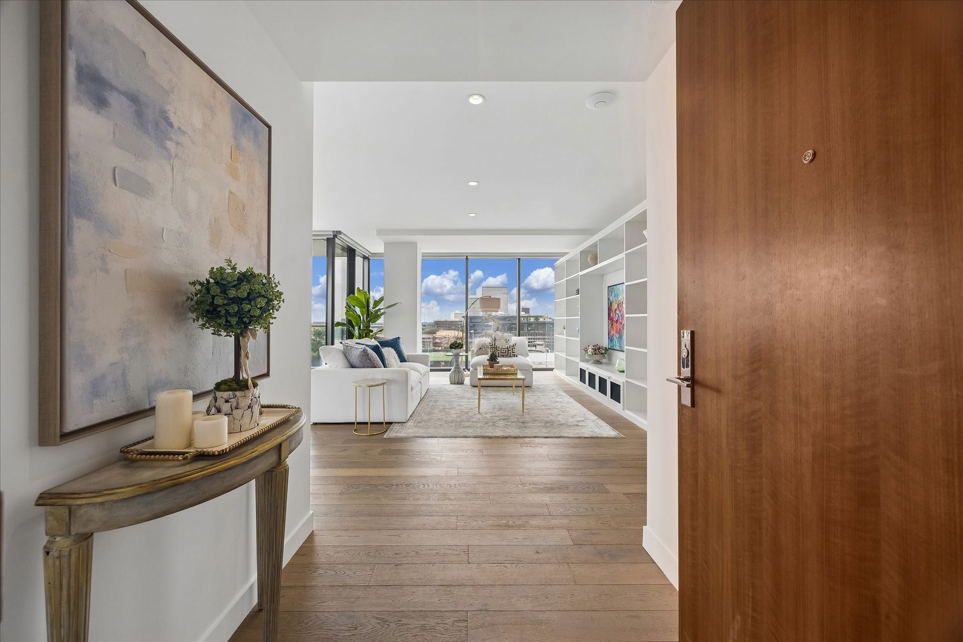 3433 Westheimer Road, #702, Houston, TX 77027 A gracious gallery-style entry sets the tone for sophisticated living, drawing your eye toward dramatic skyline vistas beyond.