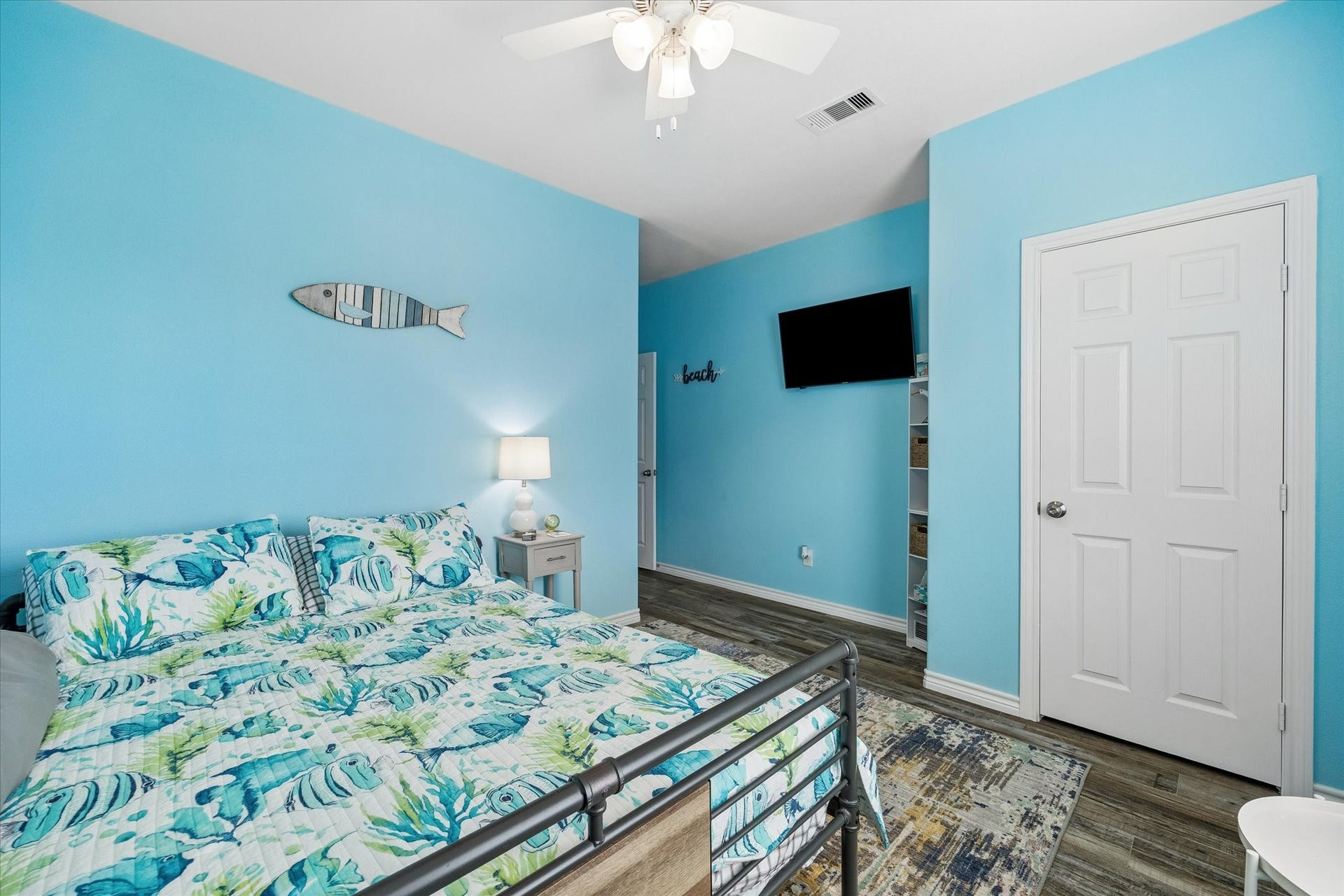 161 Four Master Road, Freeport, TX 77541 Bright and inviting bedroom with coastal-themed decor, featuring a comfortable bed, soothing blue walls, and modern flooring.
