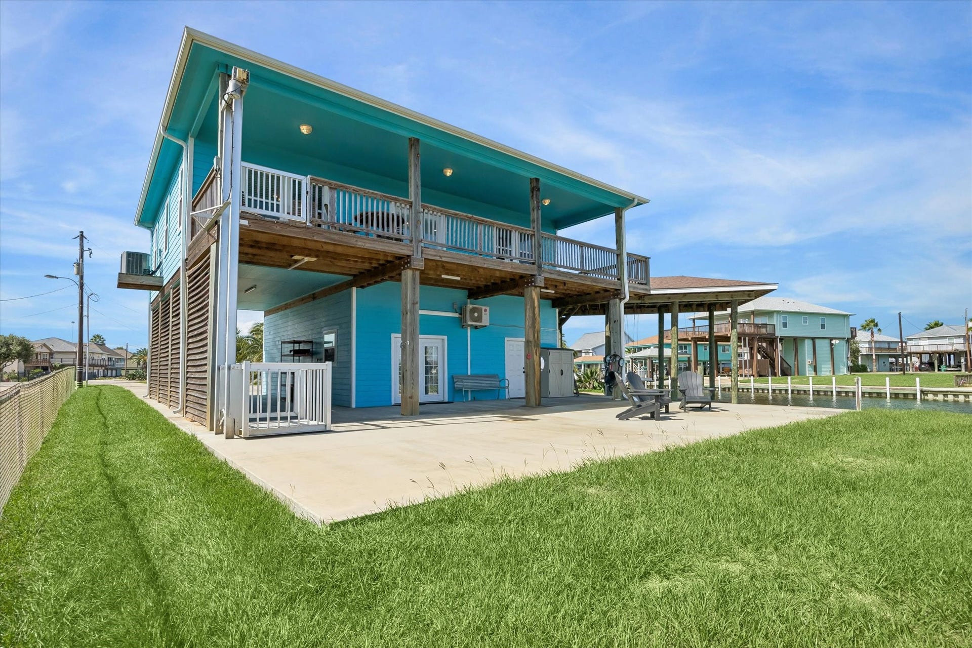 161 Four Master Road, Freeport, TX 77541 Vibrant coastal home boasting an elevated design with an expansive deck and spacious outdoor entertaining area.