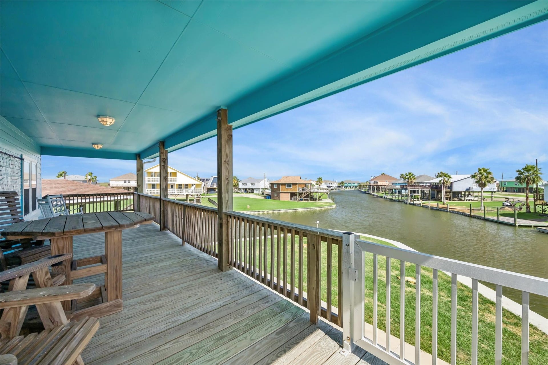 161 Four Master Road, Freeport, TX 77541 Expansive waterfront balcony offers breathtaking canal views, ideal for relaxation and entertaining.