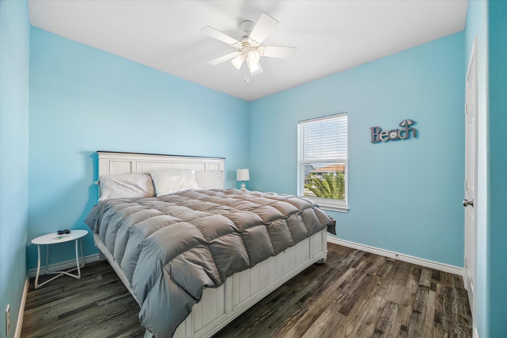 161 Four Master Road, Freeport, TX 77541 Experience serene comfort in this inviting bedroom with soothing blue tones, featuring an en suite bath for ultimate convenience.