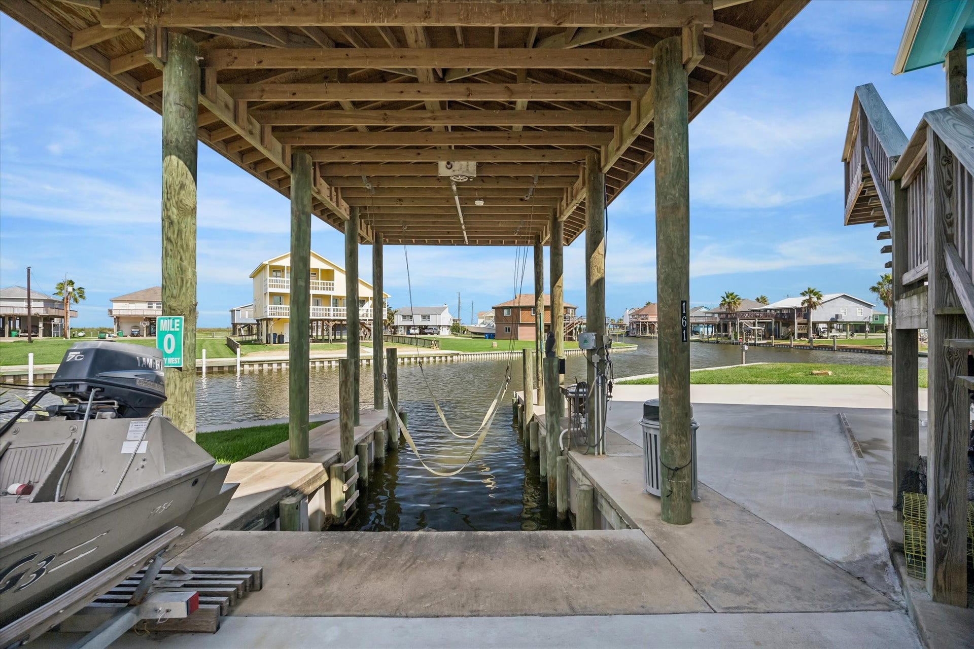 161 Four Master Road, Freeport, TX 77541 Charming waterfront property with a covered boat lift, offering direct canal access and stunning views. Perfect for boating enthusiasts seeking a serene coastal lifestyle.
