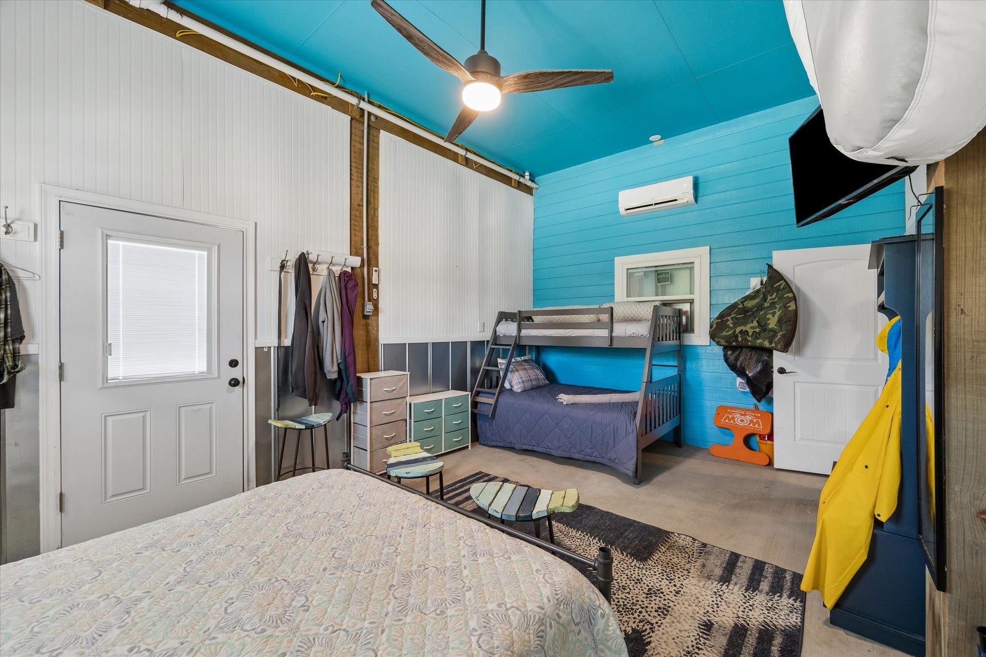 161 Four Master Road, Freeport, TX 77541 Bright and spacious bedroom featuring high ceilings, a ceiling fan, and colorful accents, and a convenient exterior door.