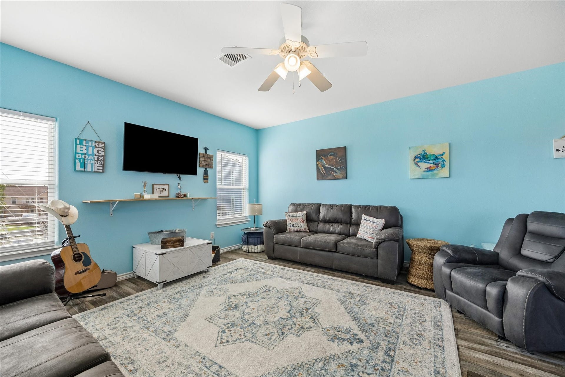 161 Four Master Road, Freeport, TX 77541 Bright and inviting living room with a soothing blue accent wall.