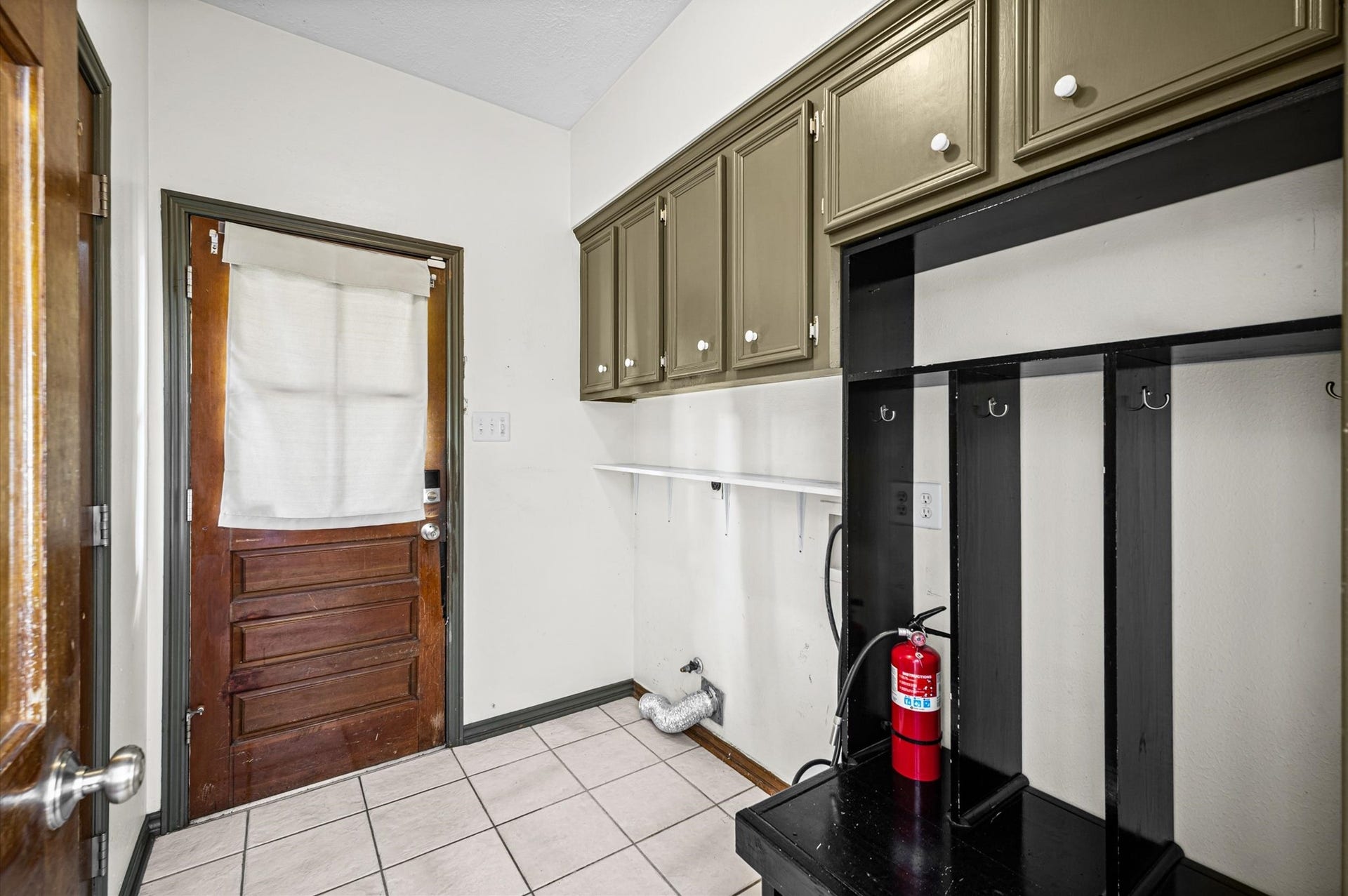 13126 Lemur Lane, Cypress, TX 77429 Laundry room located downstairs with built-in nook for backpacks or bags and all the shoes! The half bath is also located off the laundry room.