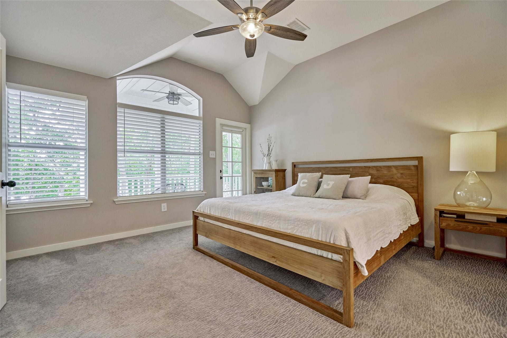 38 E Gaslight Place, The Woodlands, TX 77382 The large primary bedroom on the second floor! Vaulted ceilings, updated fans, lighting and recent carpet. There is a lovely balcony directly located off the main bedroom.