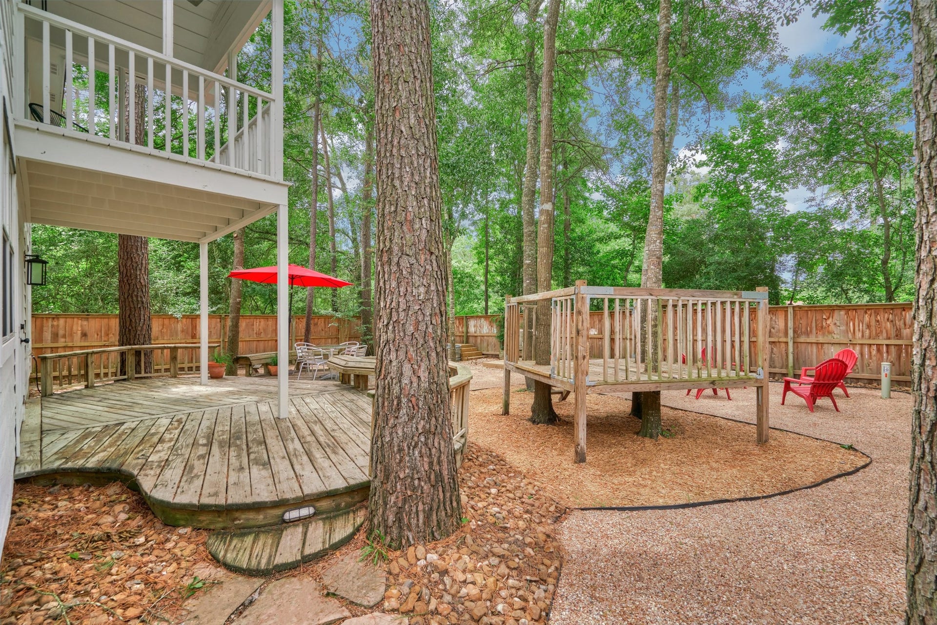 38 E Gaslight Place, The Woodlands, TX 77382 The large backyard with covered deck and play space!