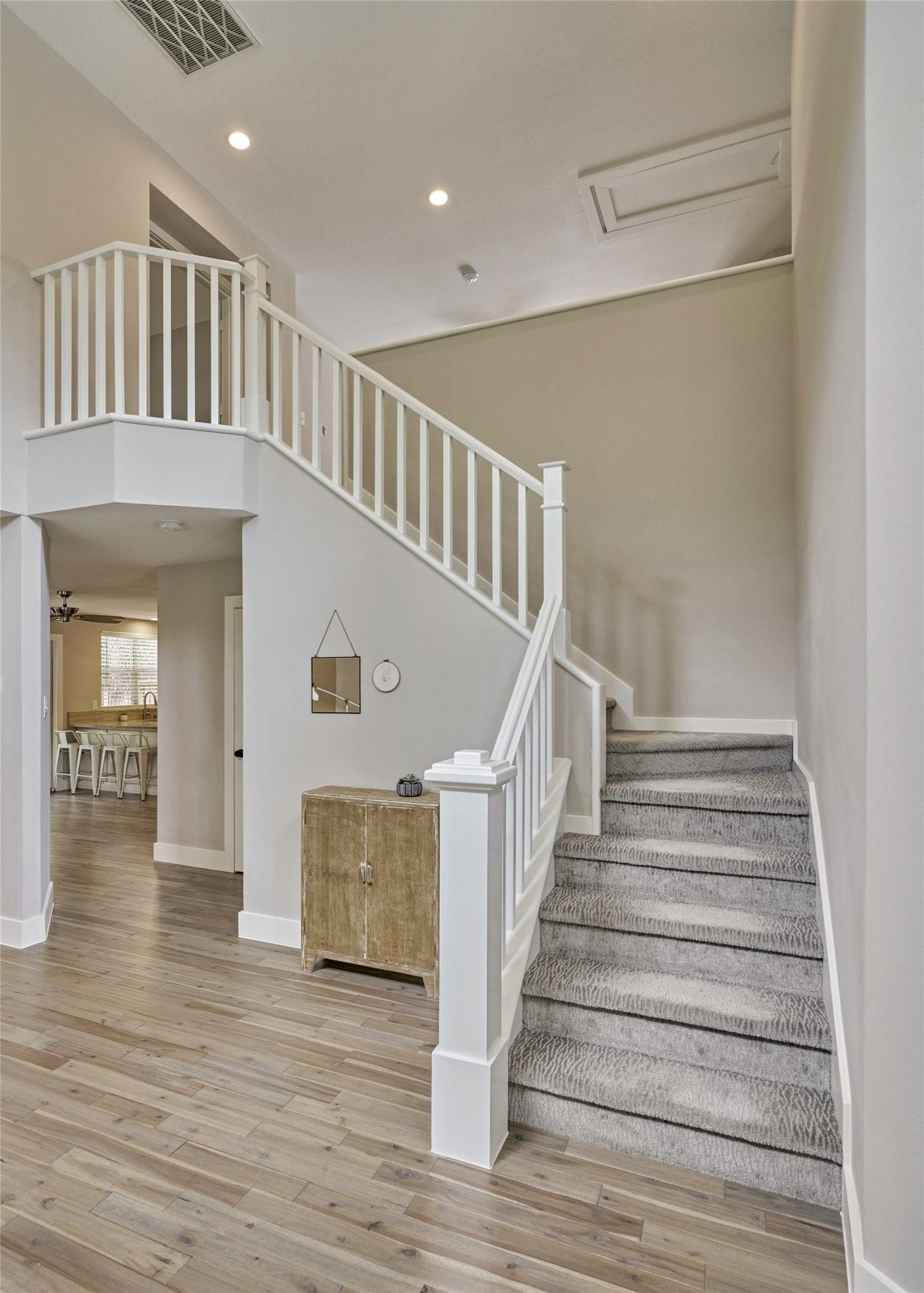 38 E Gaslight Place, The Woodlands, TX 77382 The beautiful staircase in the home. The whole lower level is all hardwood floors and carpet on the second floor. The whole home was remodeled throughout in 2019!