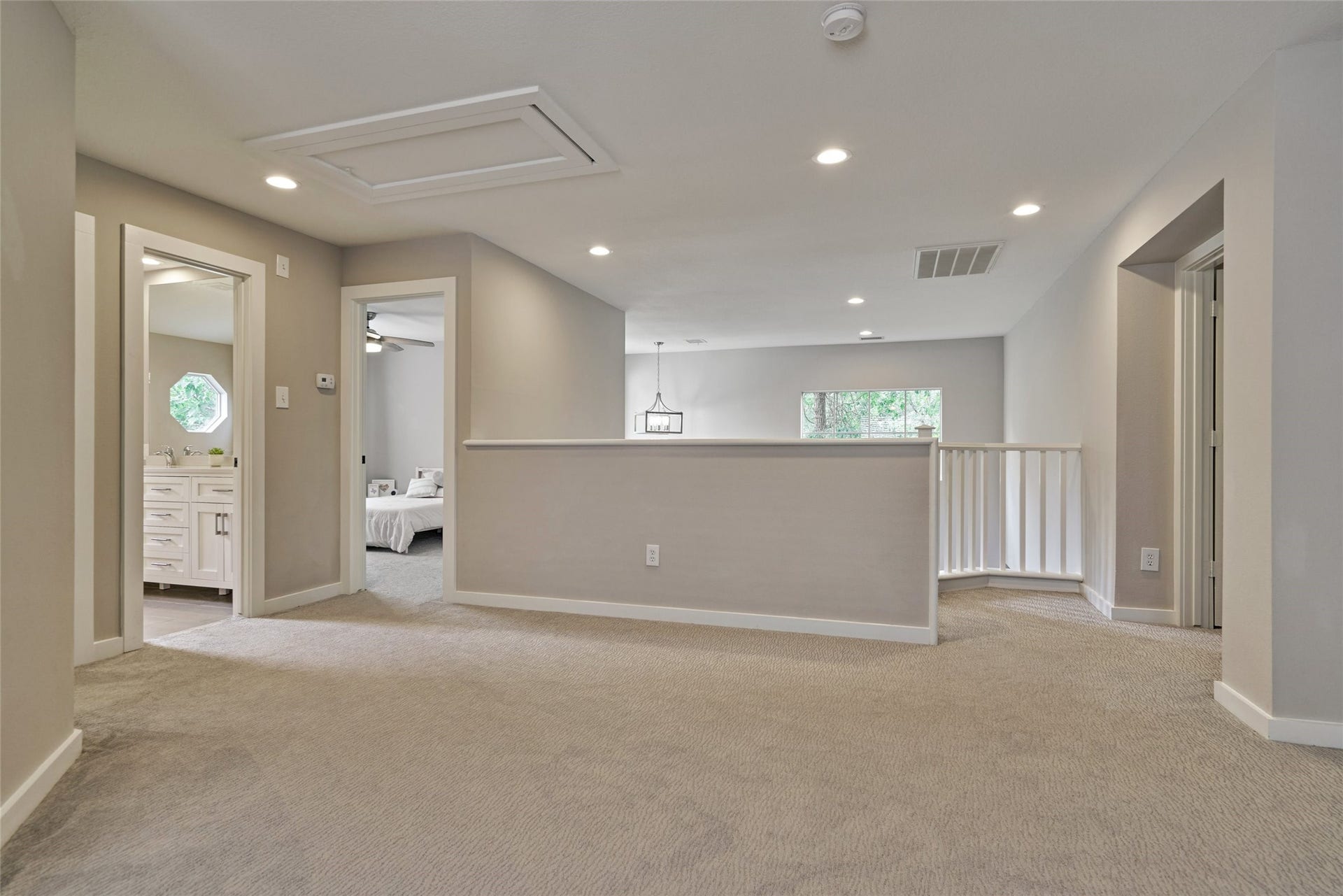 38 E Gaslight Place, The Woodlands, TX 77382 The large gameroom and landing area on the second floor.The whole home has had new wood trim detail added around the doors and baseboards. Carpet replaced in 2019 along with all fans, lighting and hardware!